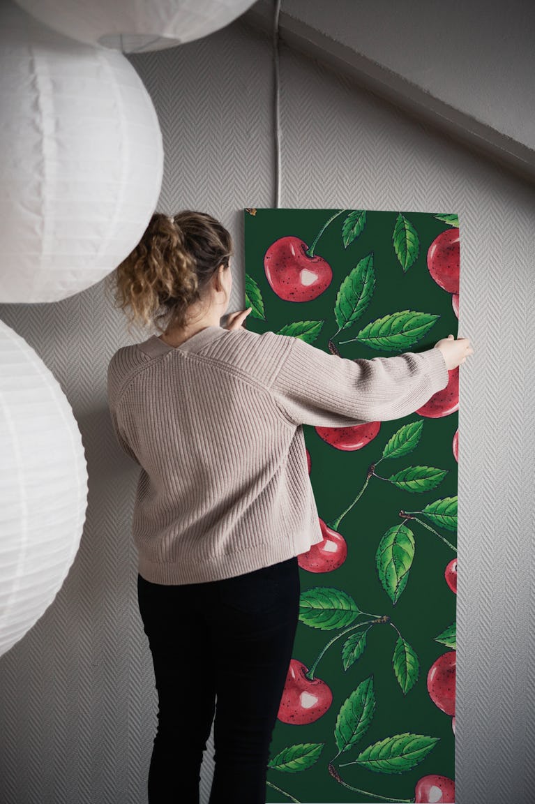 Red cherries on dark green wallpaper roll