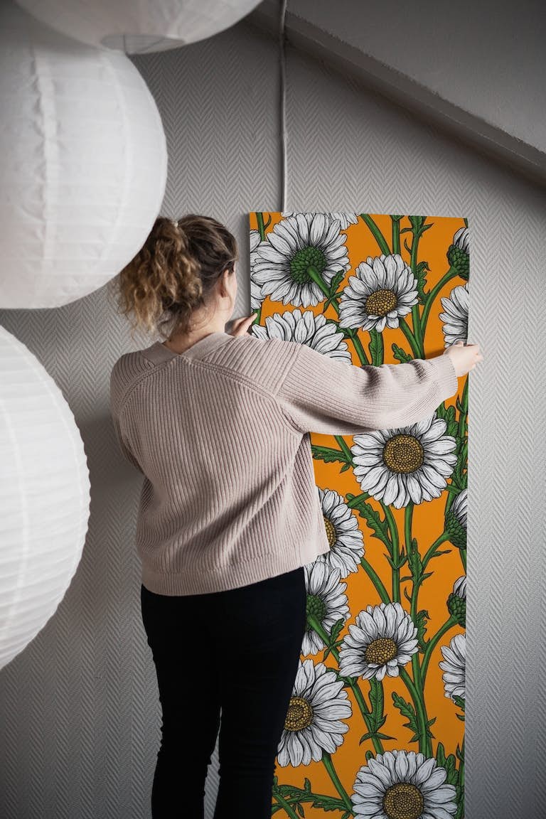 Daisies on orange wallpaper roll