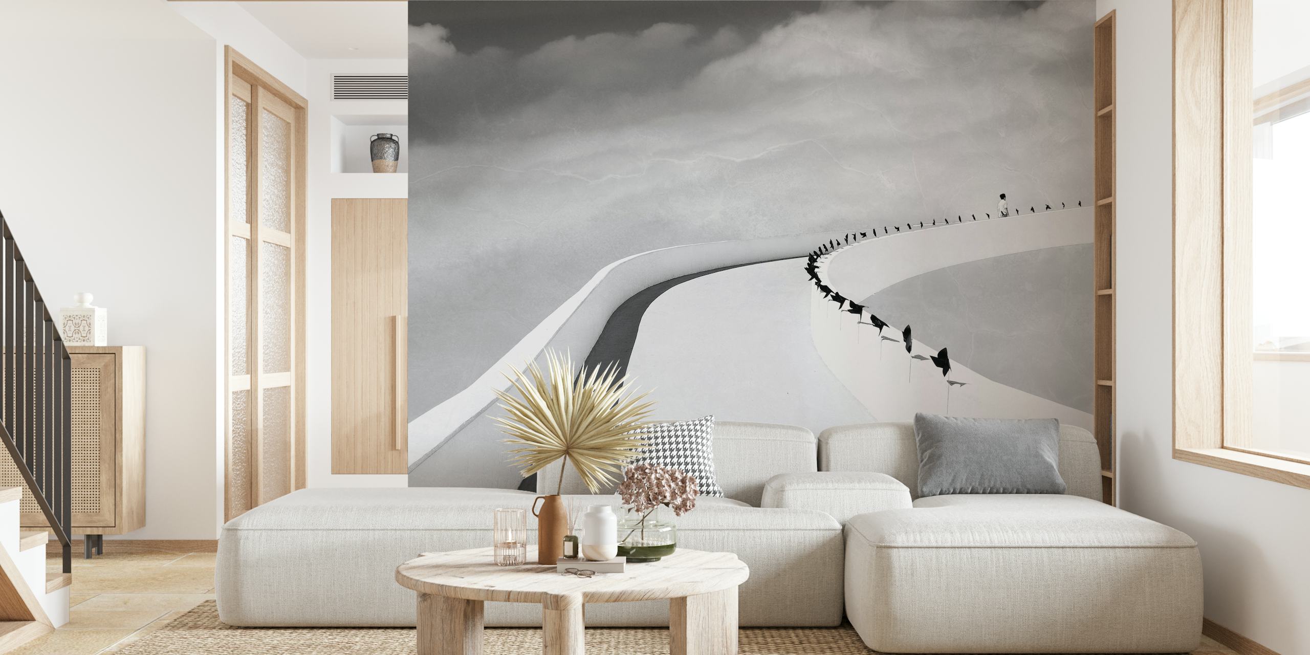 Monochrome wall mural with people on a winding road leading to the horizon