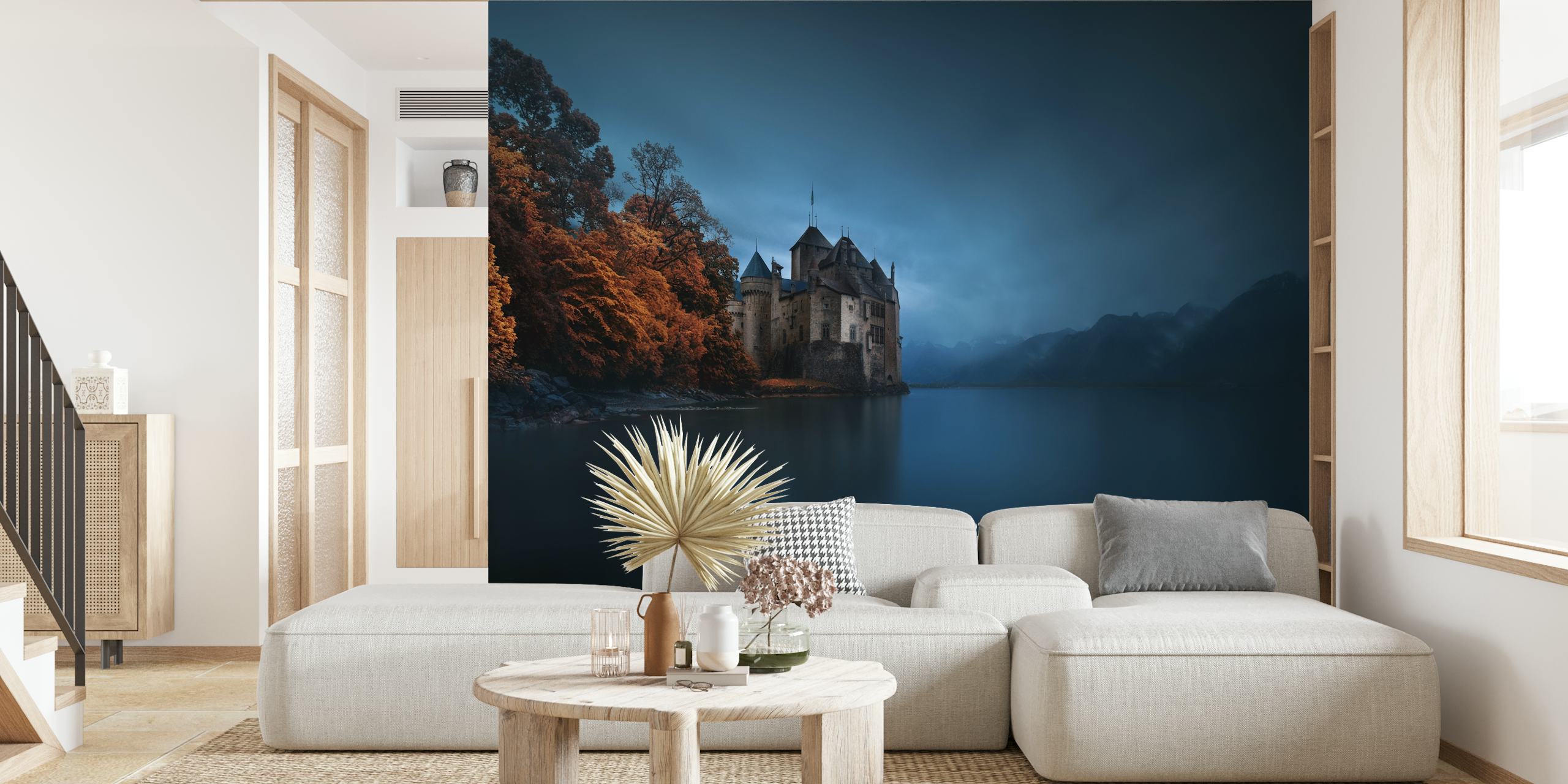 Dark castle on the edge of a serene lake surrounded by autumn foliage and mountains wallpaper