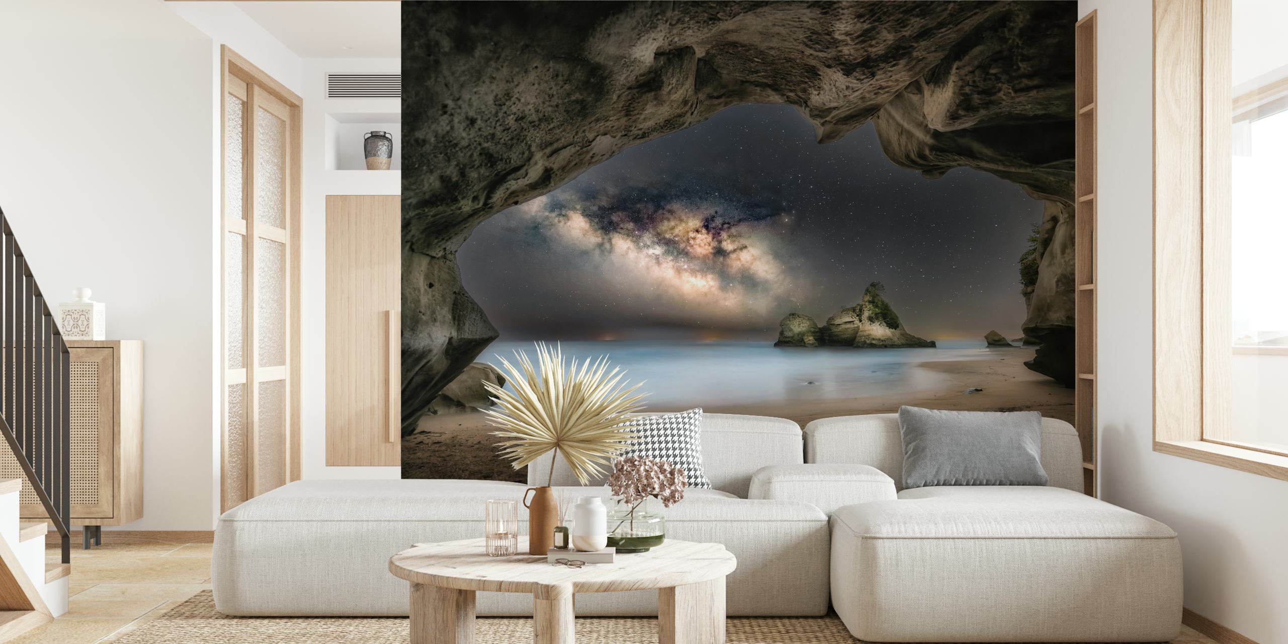 Rocky cave with starry night sky and ocean wallpaper