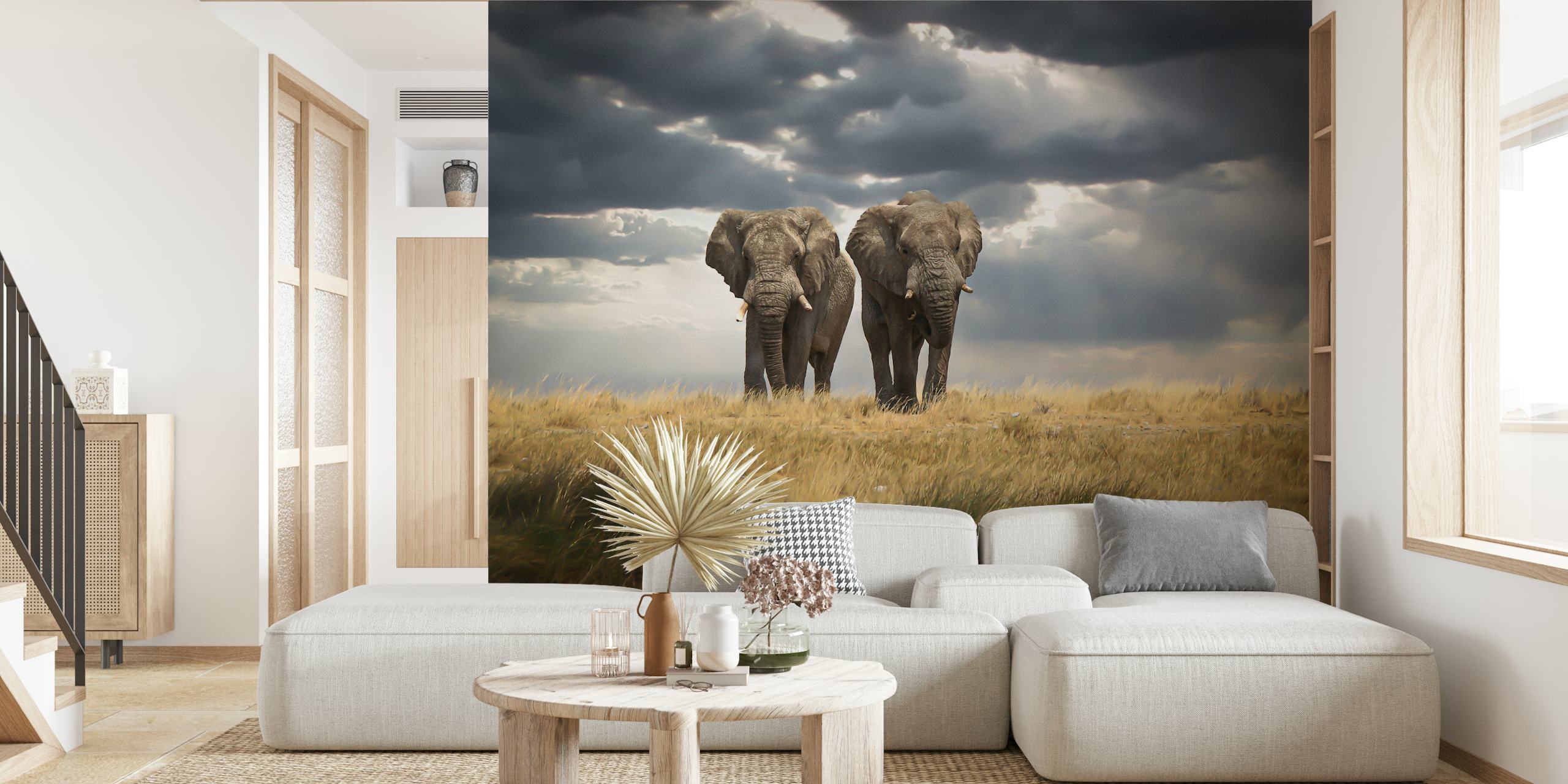 Elephants standing in a grassland under cloudy sky wallpaper