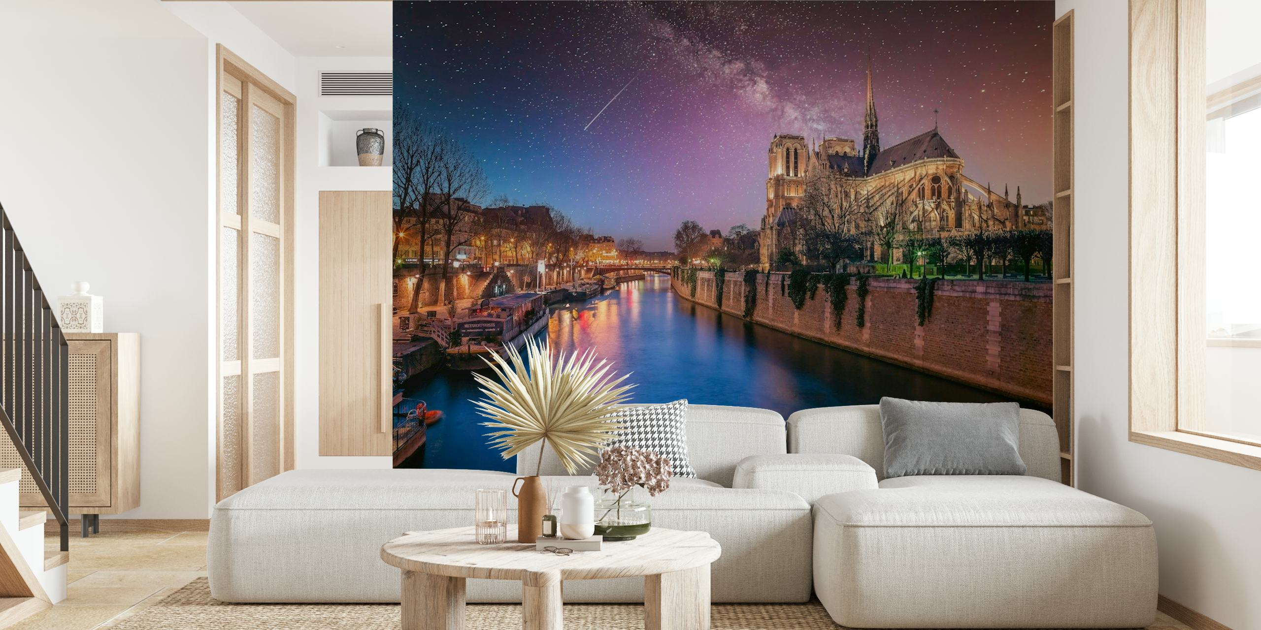 Notre-Dame cathedral against a starry night sky with the Seine River in the foreground.