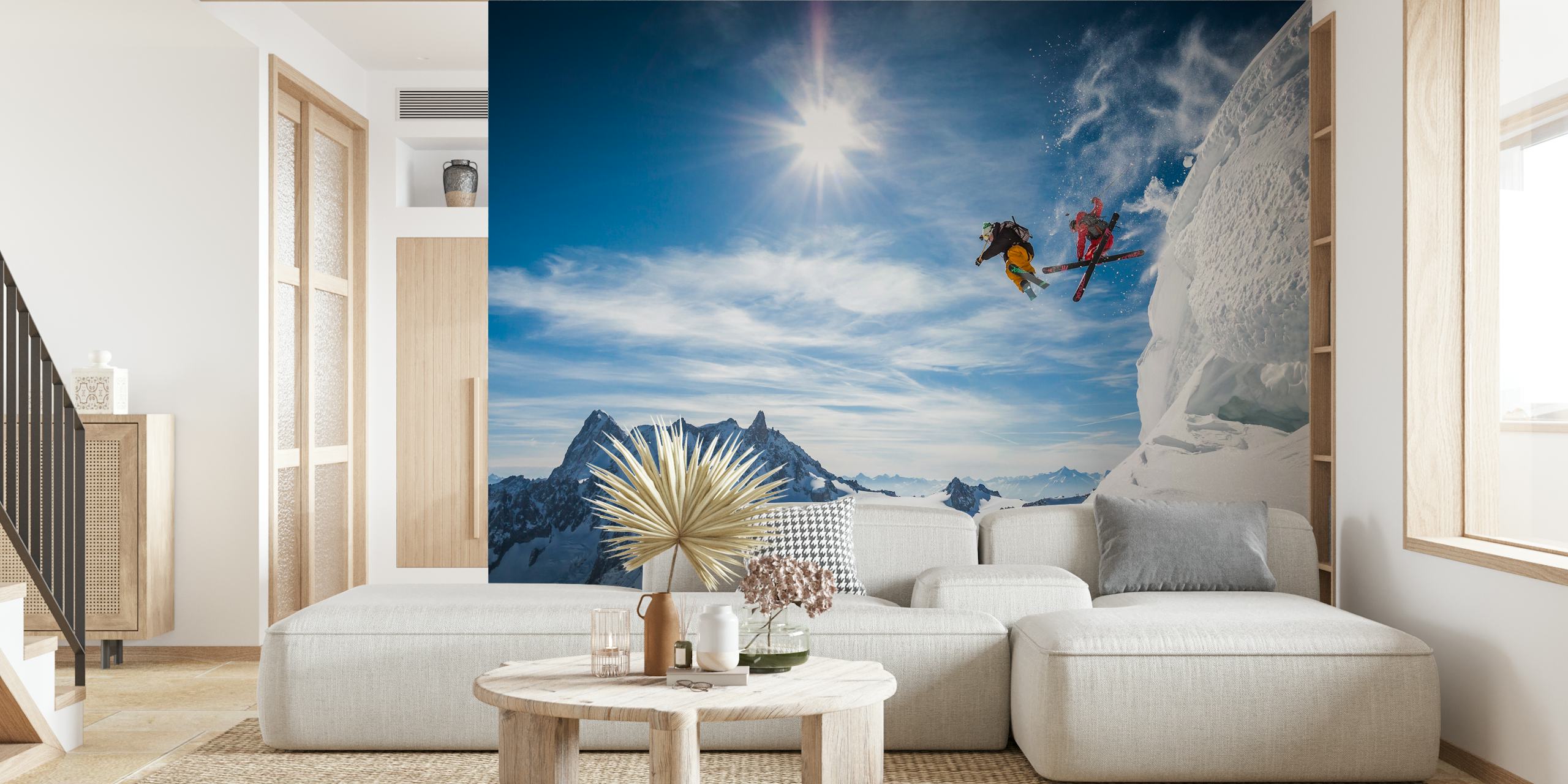 Two skiers jumping over snowy mountains with a bright blue sky, action-packed wallpaper