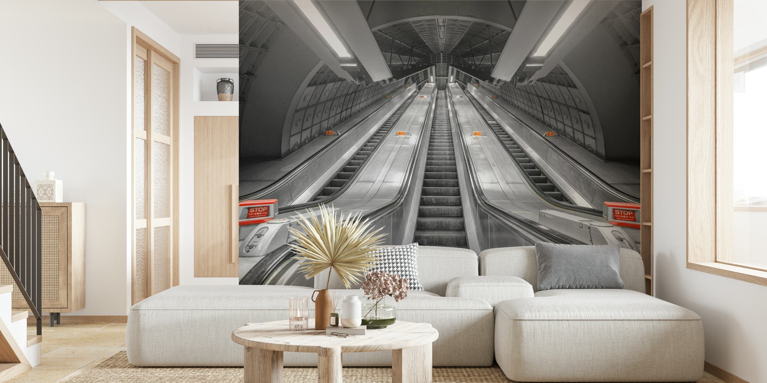 Black and white wall mural of subway escalators leading upwards in a symmetrical pattern