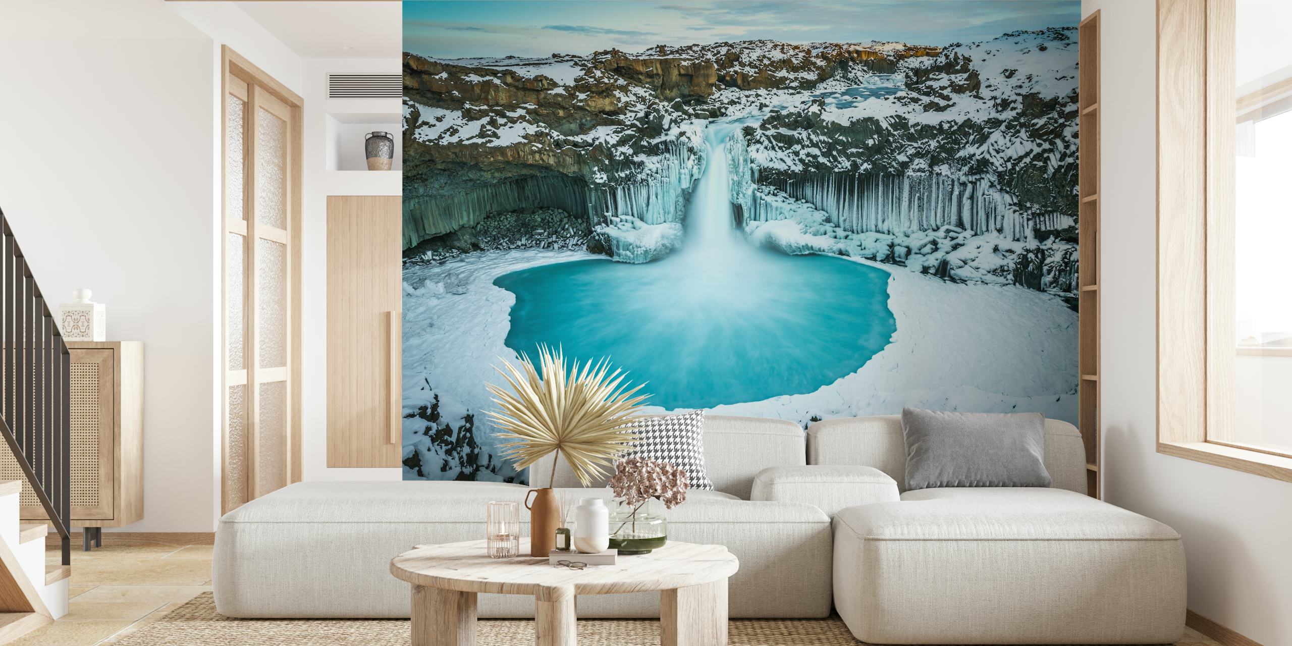 Azure blue waterfall cascading into a frozen lake wallpaper