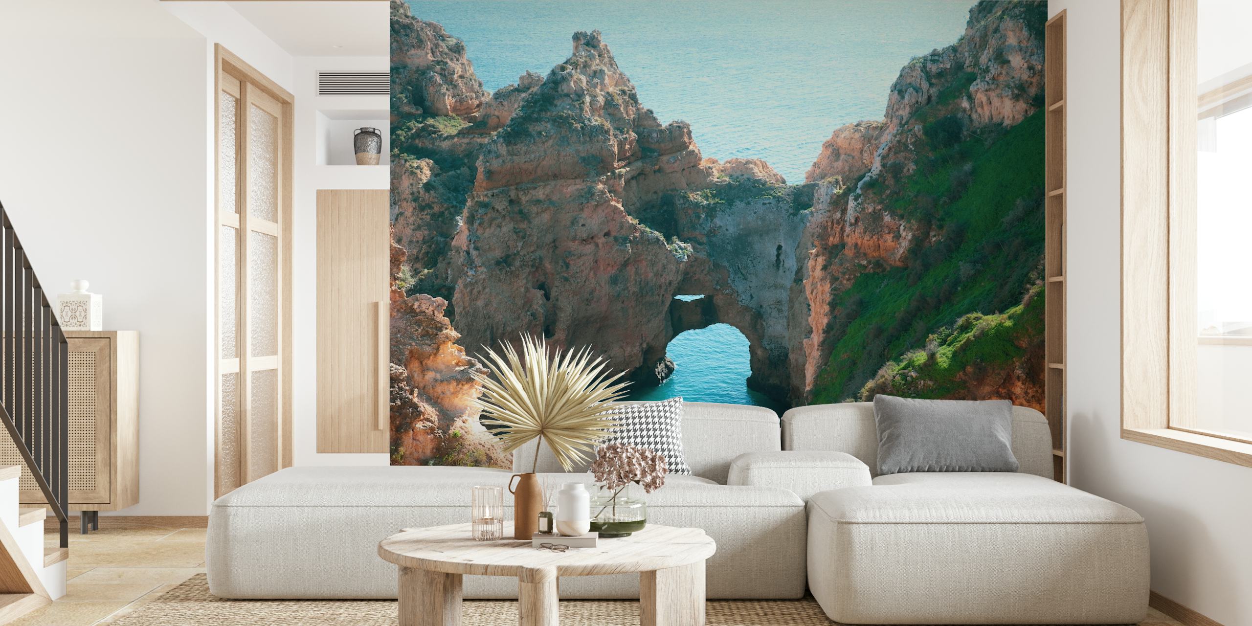 Coastal rock formations with blue water and green grass wallpaper