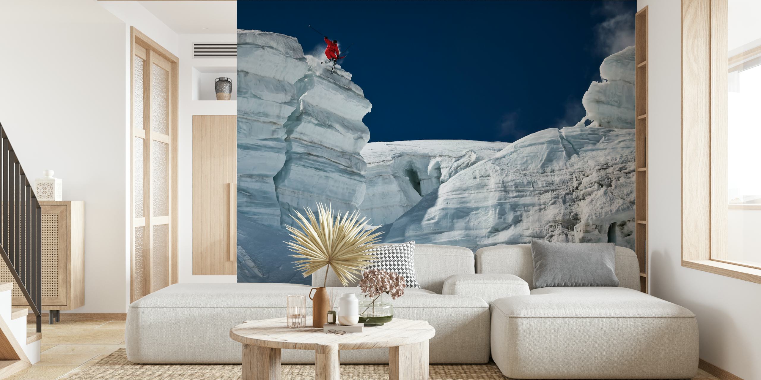 Skier on icy cliff jumping against a blue sky wallpaper