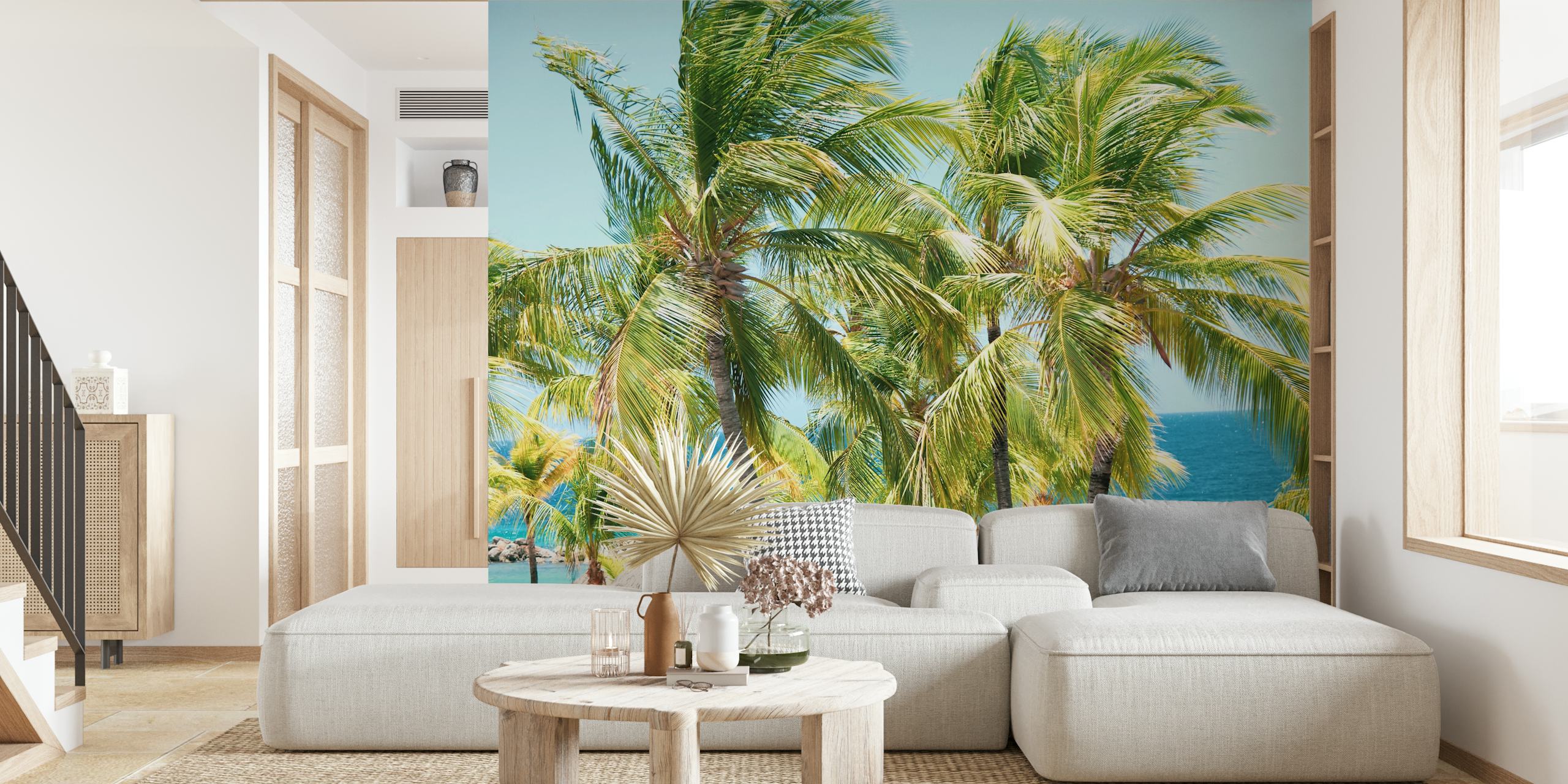 Tall green palm trees against a bright blue ocean wallpaper