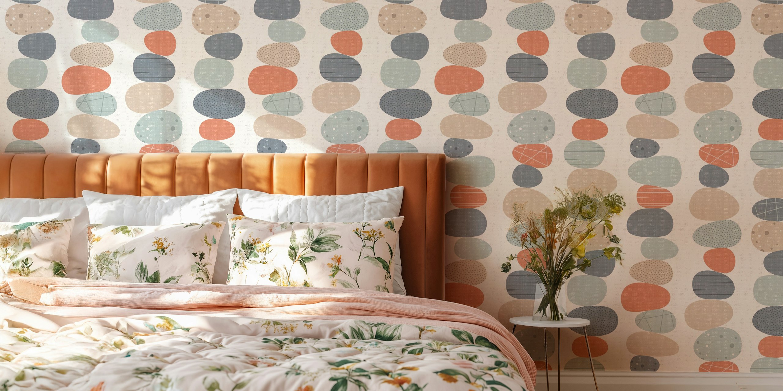 Colorful pebble stones in soft pastels on cream wallpaper