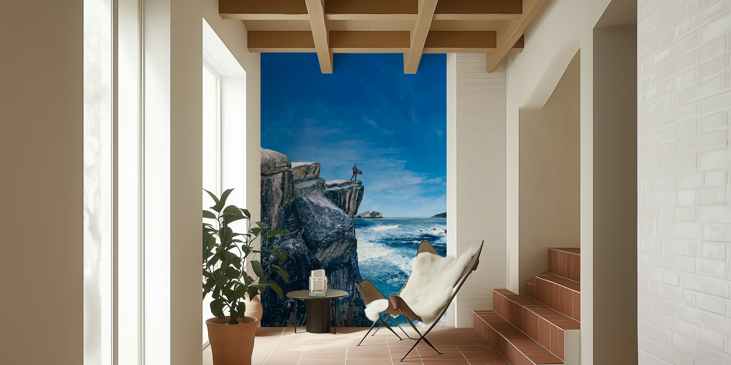 Surf waves crashing against a mountain cliff with a clear blue sky wall mural