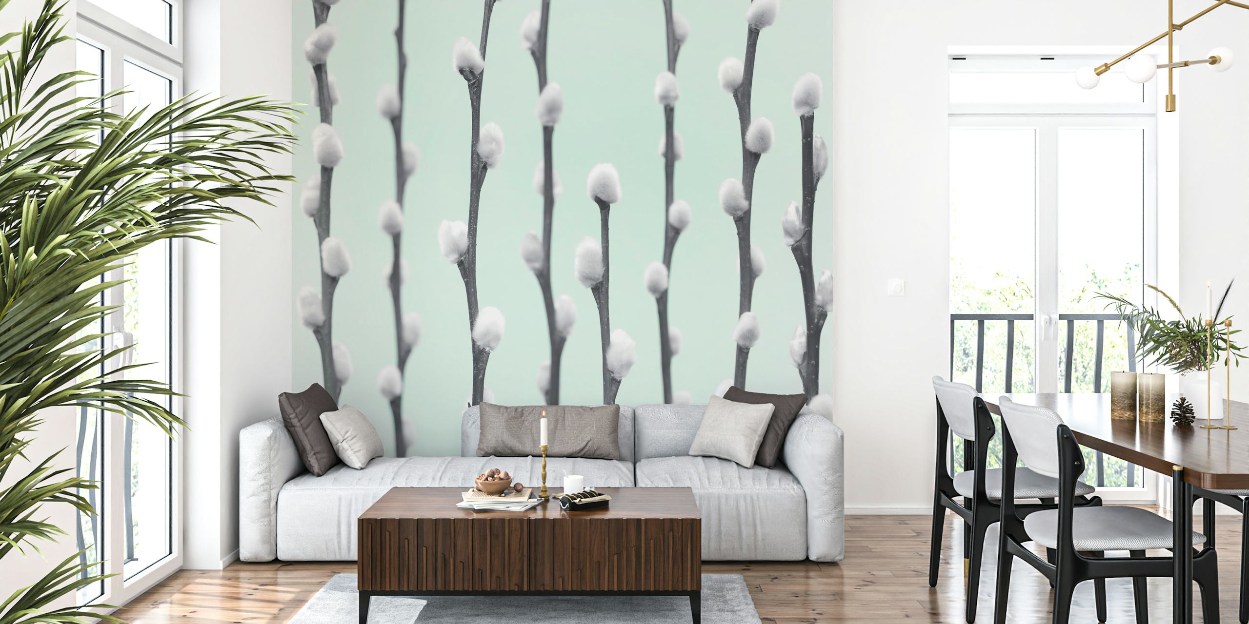 White pussy willow twigs with fluffy buds on light mint wallpaper
