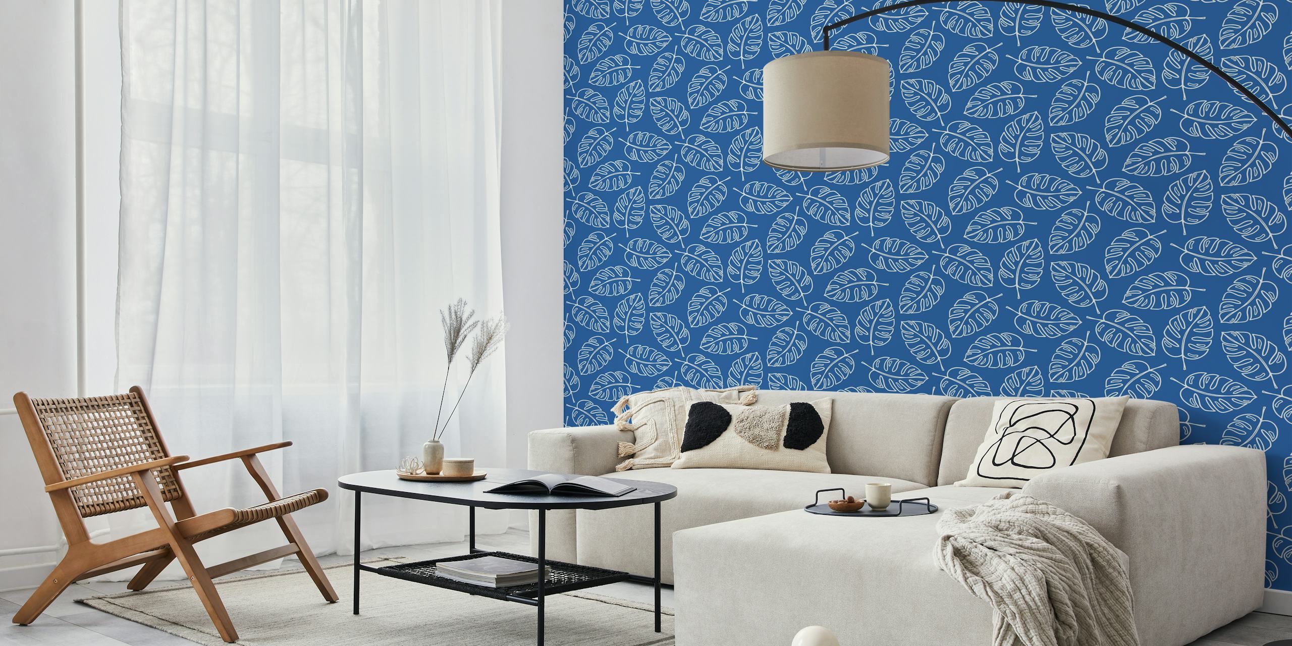 Blue wallpaper with white monstera leaves pattern