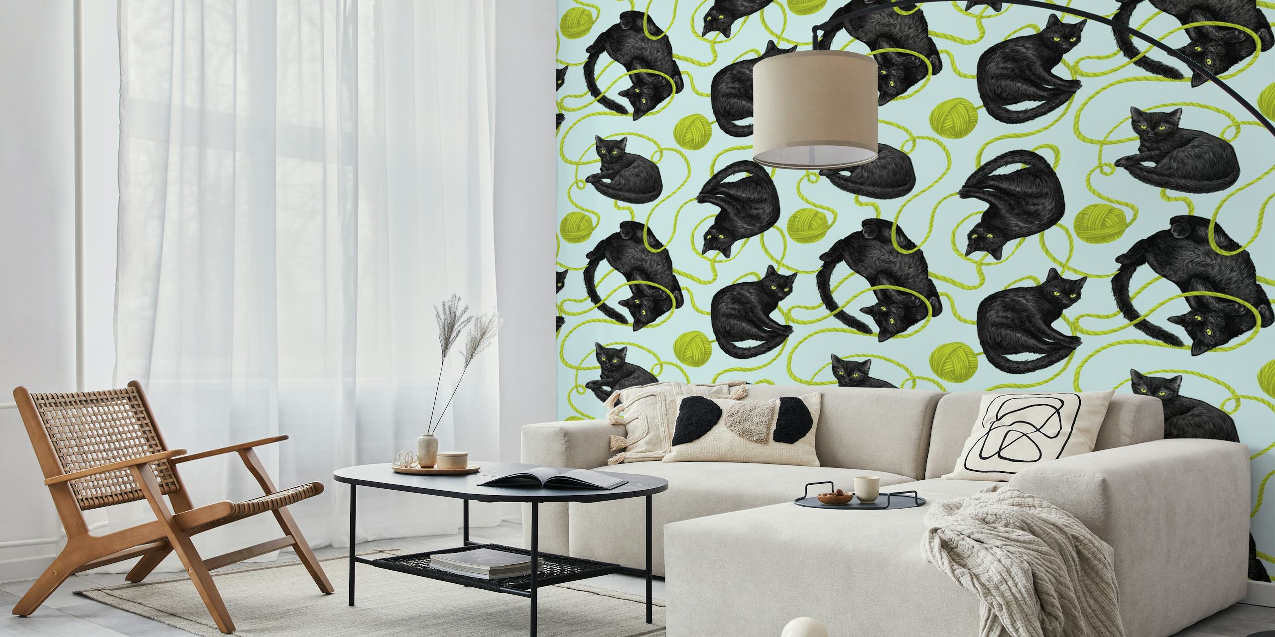 Black cats with yarn balls on green and blue wallpaper