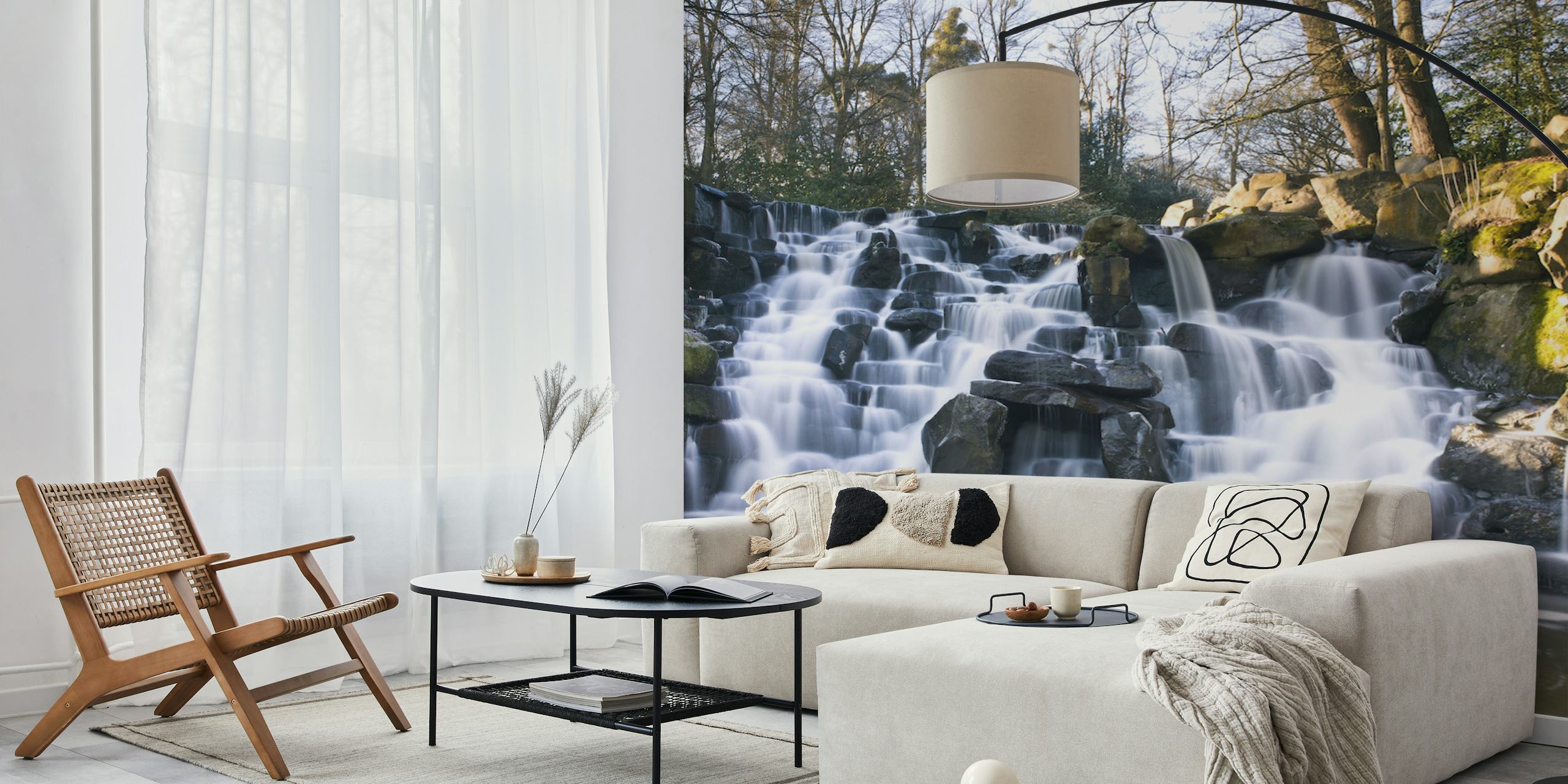 Waterfall cascading over rocks surrounded by trees wallpaper