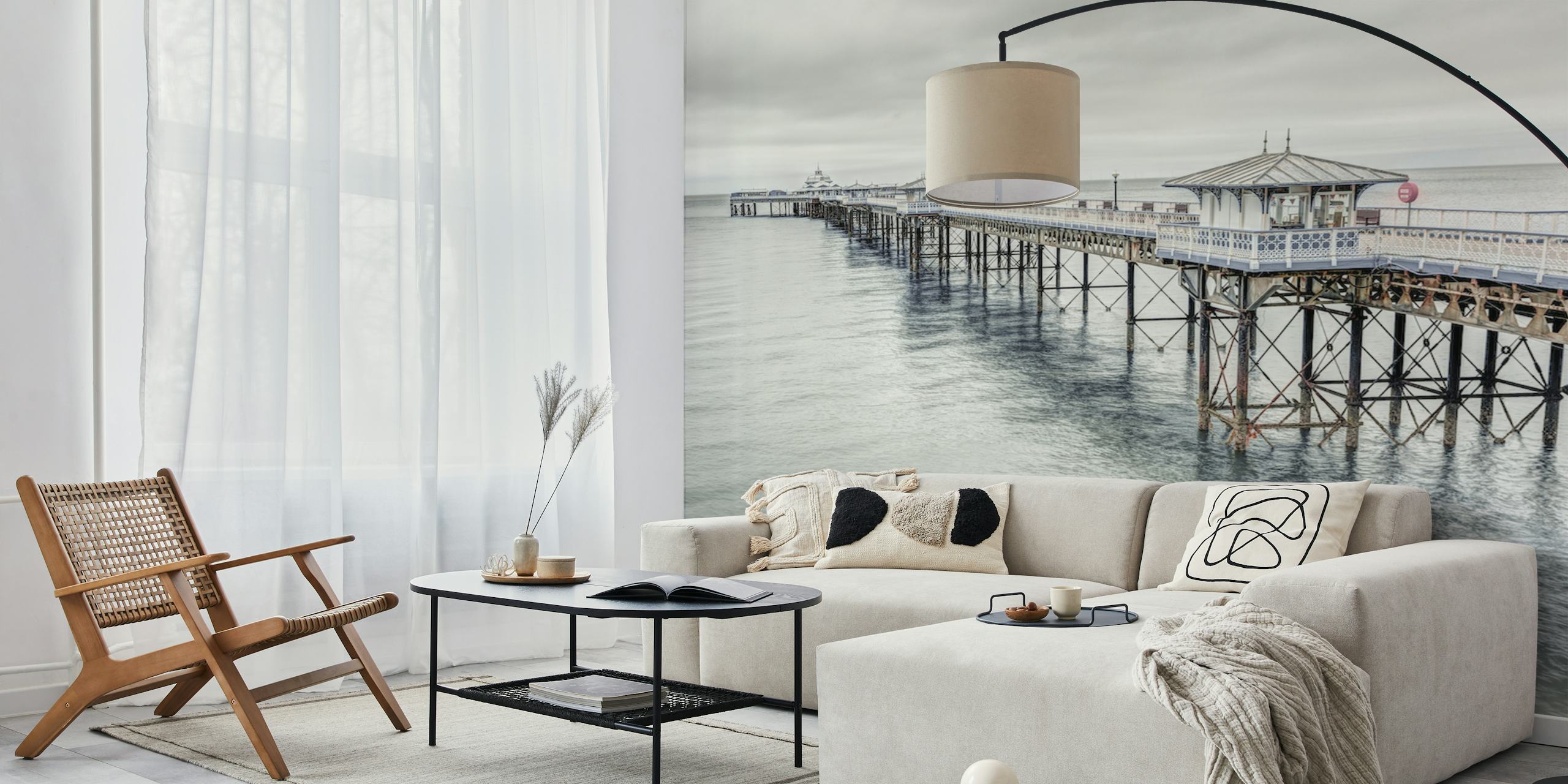 Coastal landscape wallpaper featuring Llandudno pier in muted greys and blues, realistic photography style.