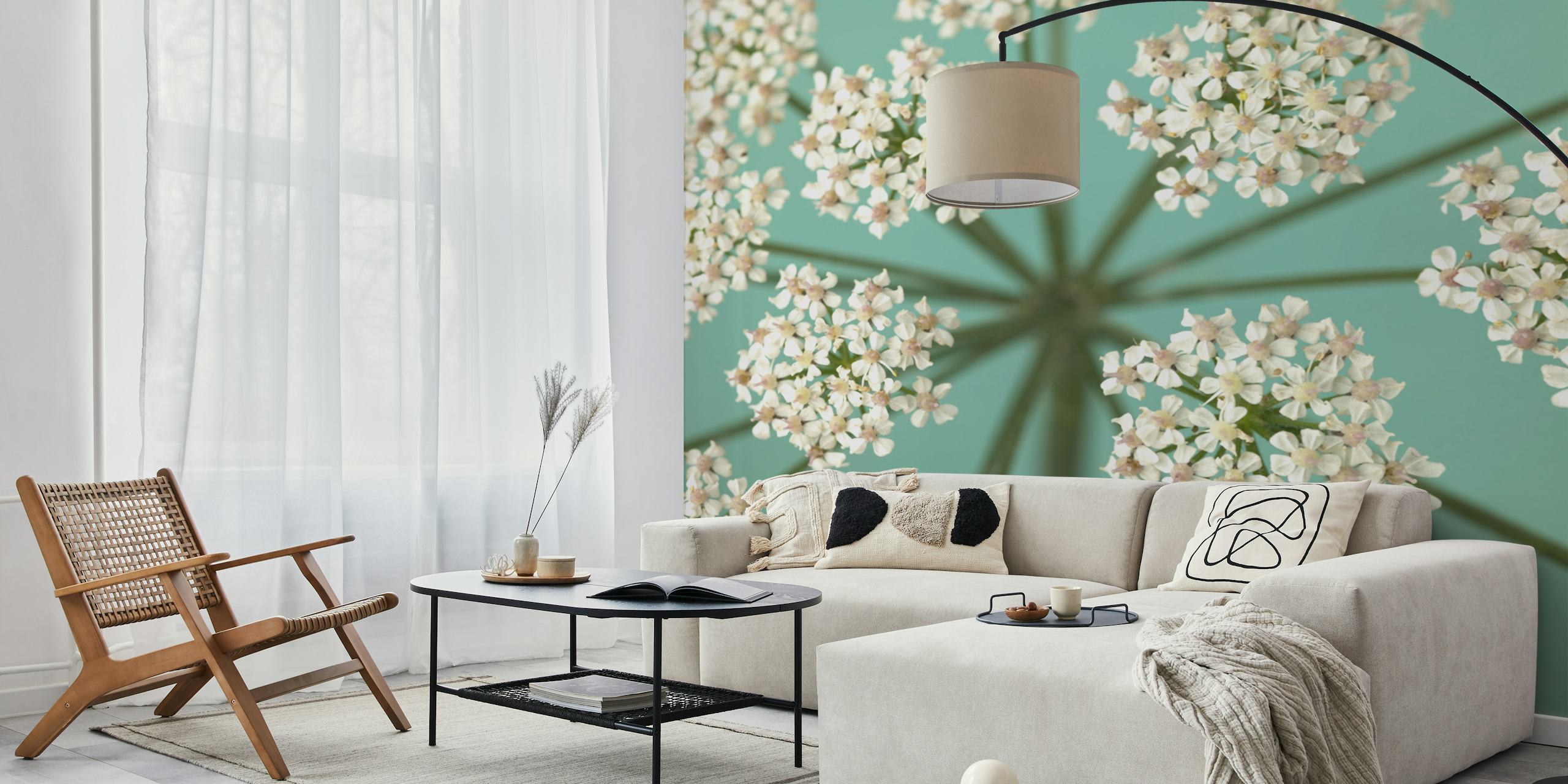 Delicate floral pattern with white and pale pink flowers on teal wallpaper