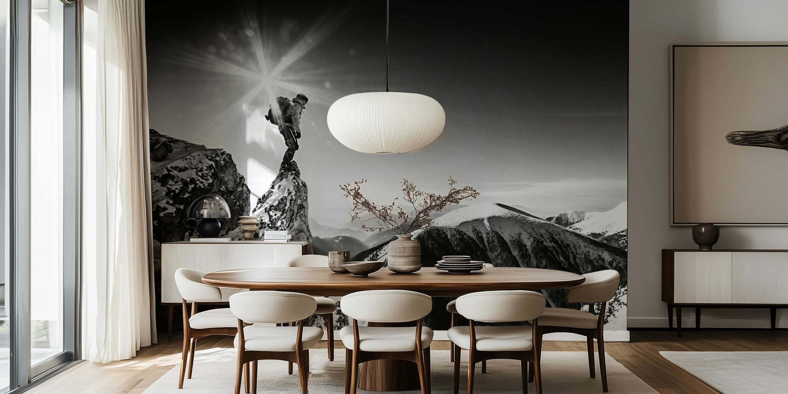A climber on a snowy mountain peak under a bright sunburst black and white wallpaper