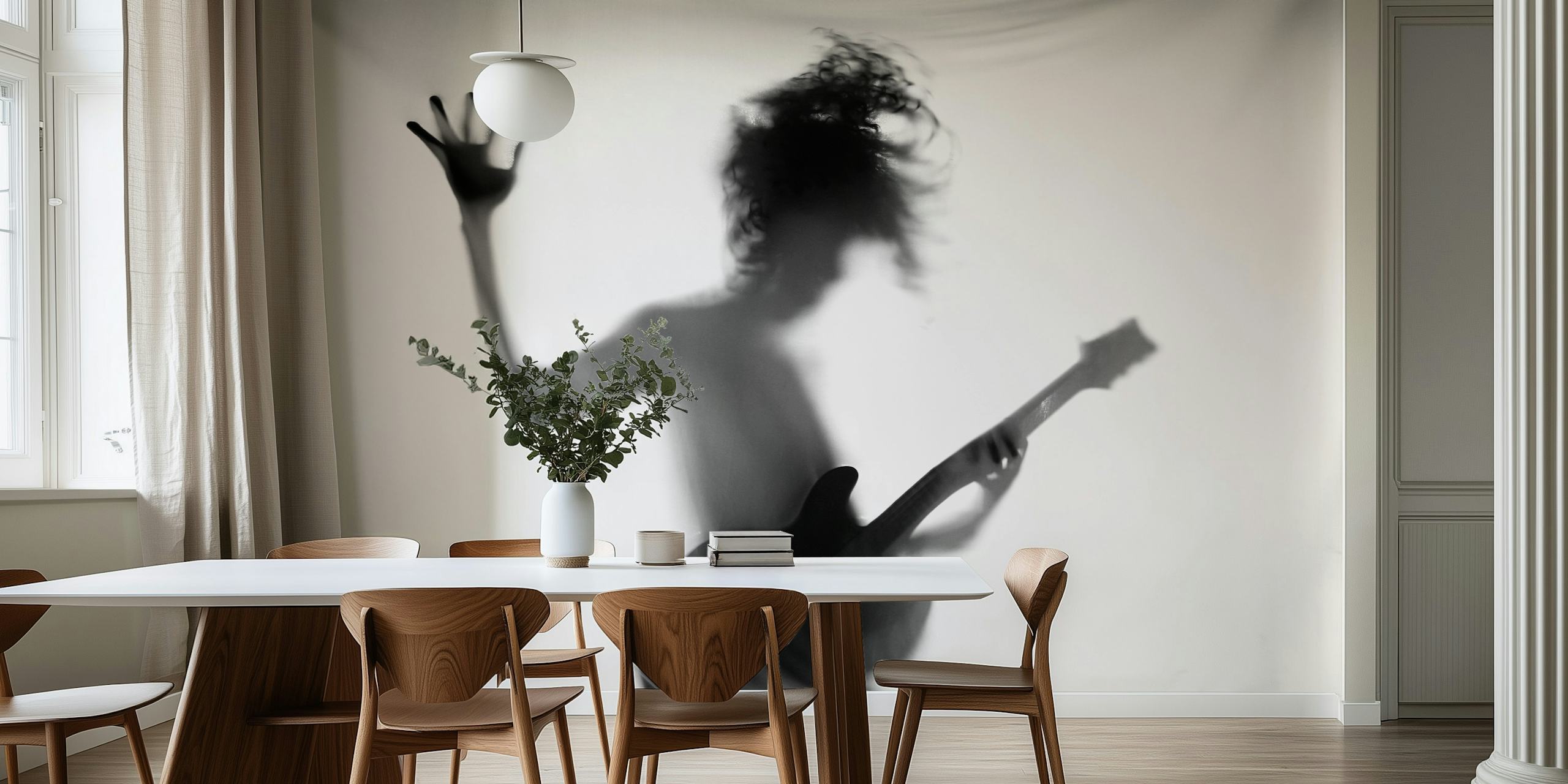 Silhouette of a person playing guitar in a dynamic pose in black and white.