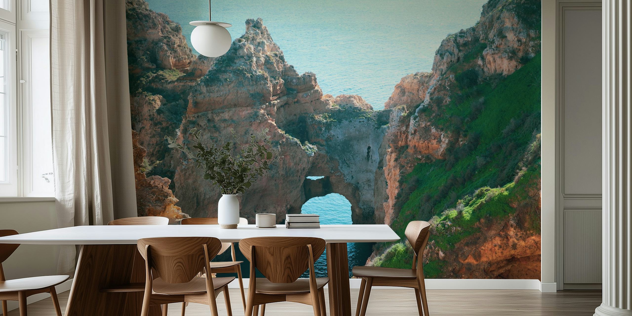 Coastal rock formations with blue water and green grass wallpaper