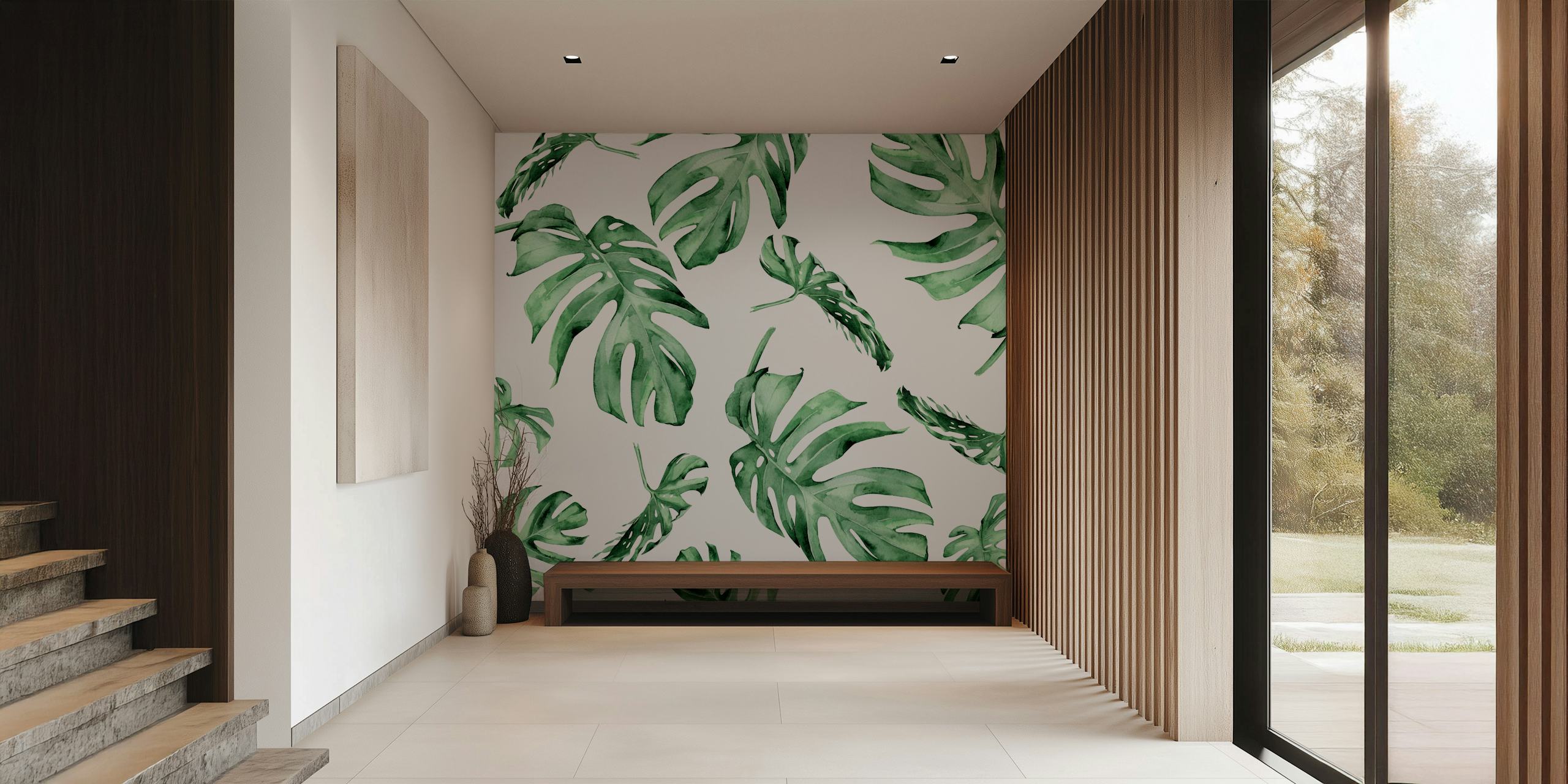 Monstera leaves in various shades of green on a white wallpaper