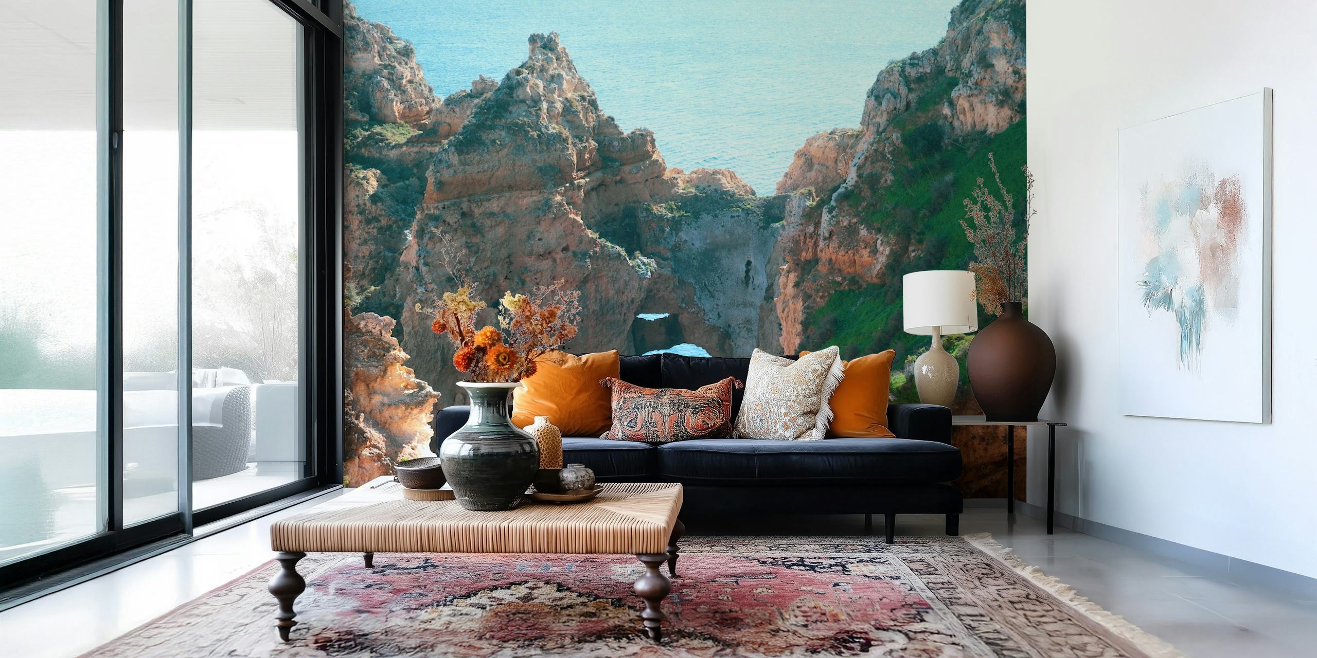 Coastal rock formations with blue water and green grass wallpaper