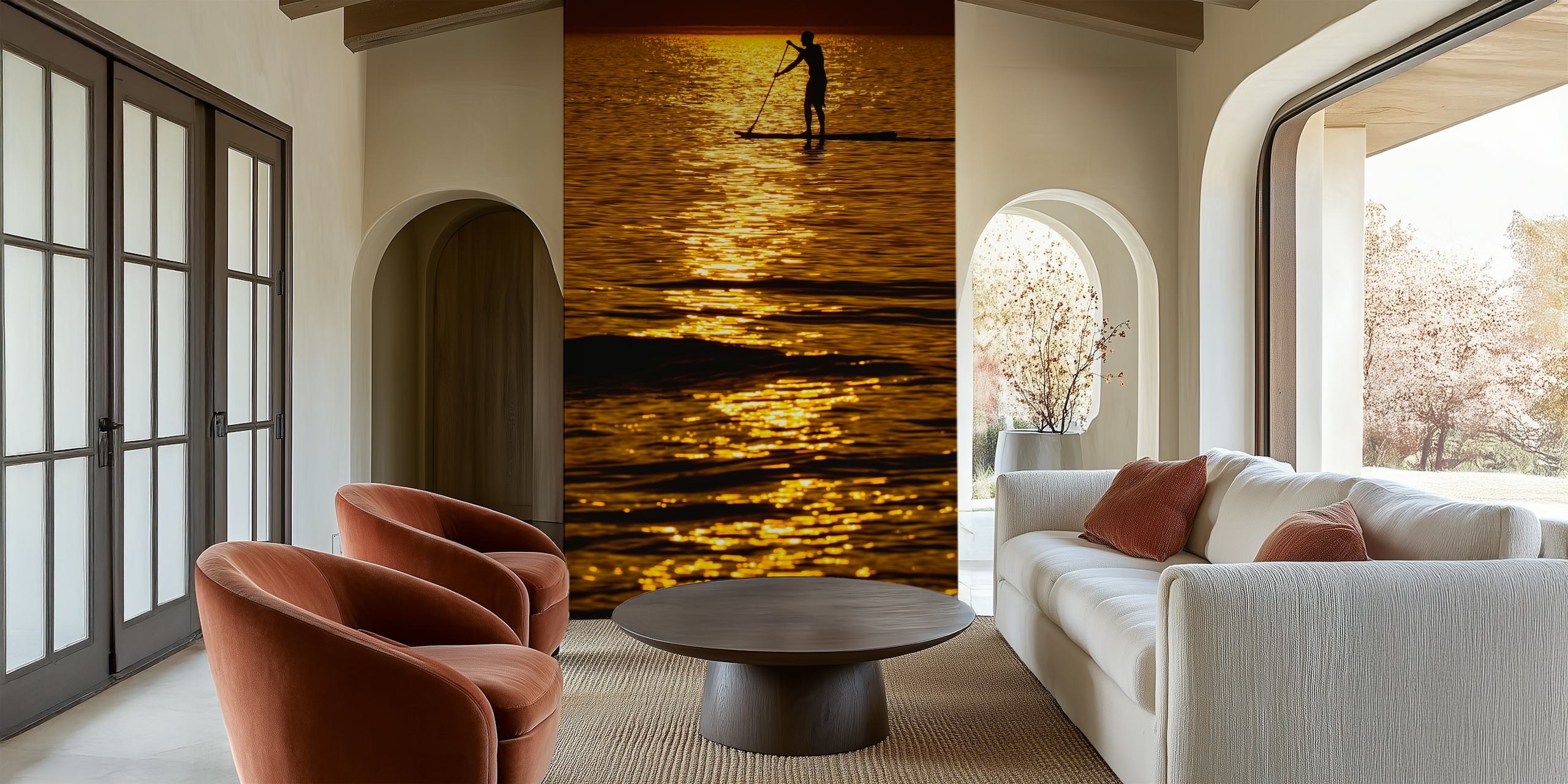 Silhouette of a person paddleboarding on a shimmering sea during a golden sunset