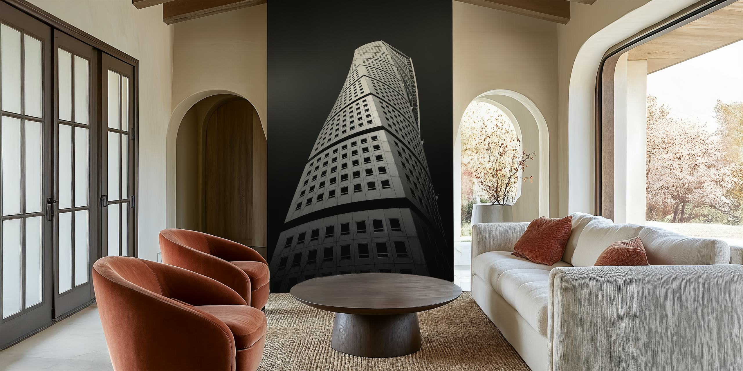 Monochrome wall mural of a twisting skyscraper against a dark sky