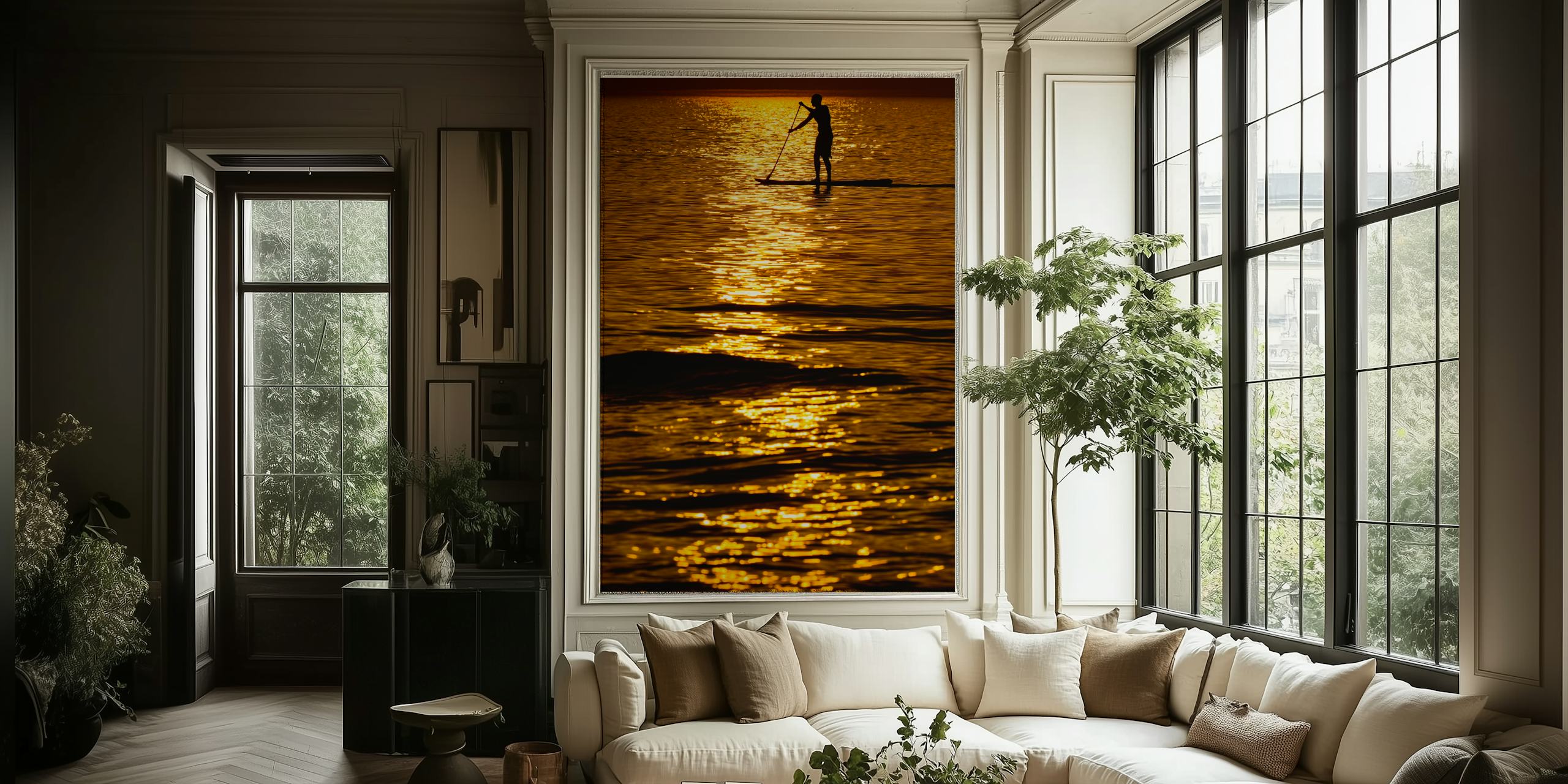 Silhouette of a person paddleboarding on a shimmering sea during a golden sunset