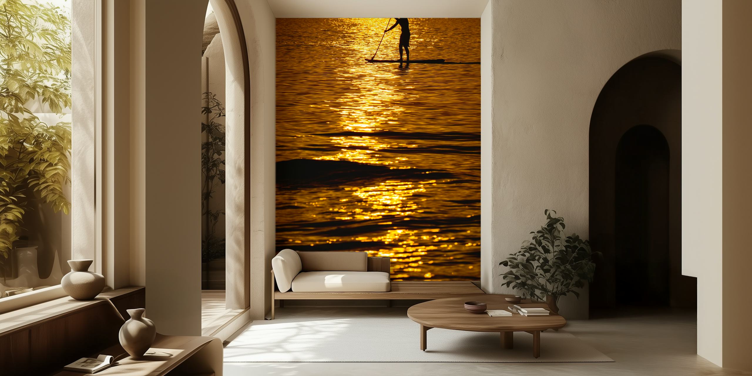 Silhouette of a person paddleboarding on a shimmering sea during a golden sunset