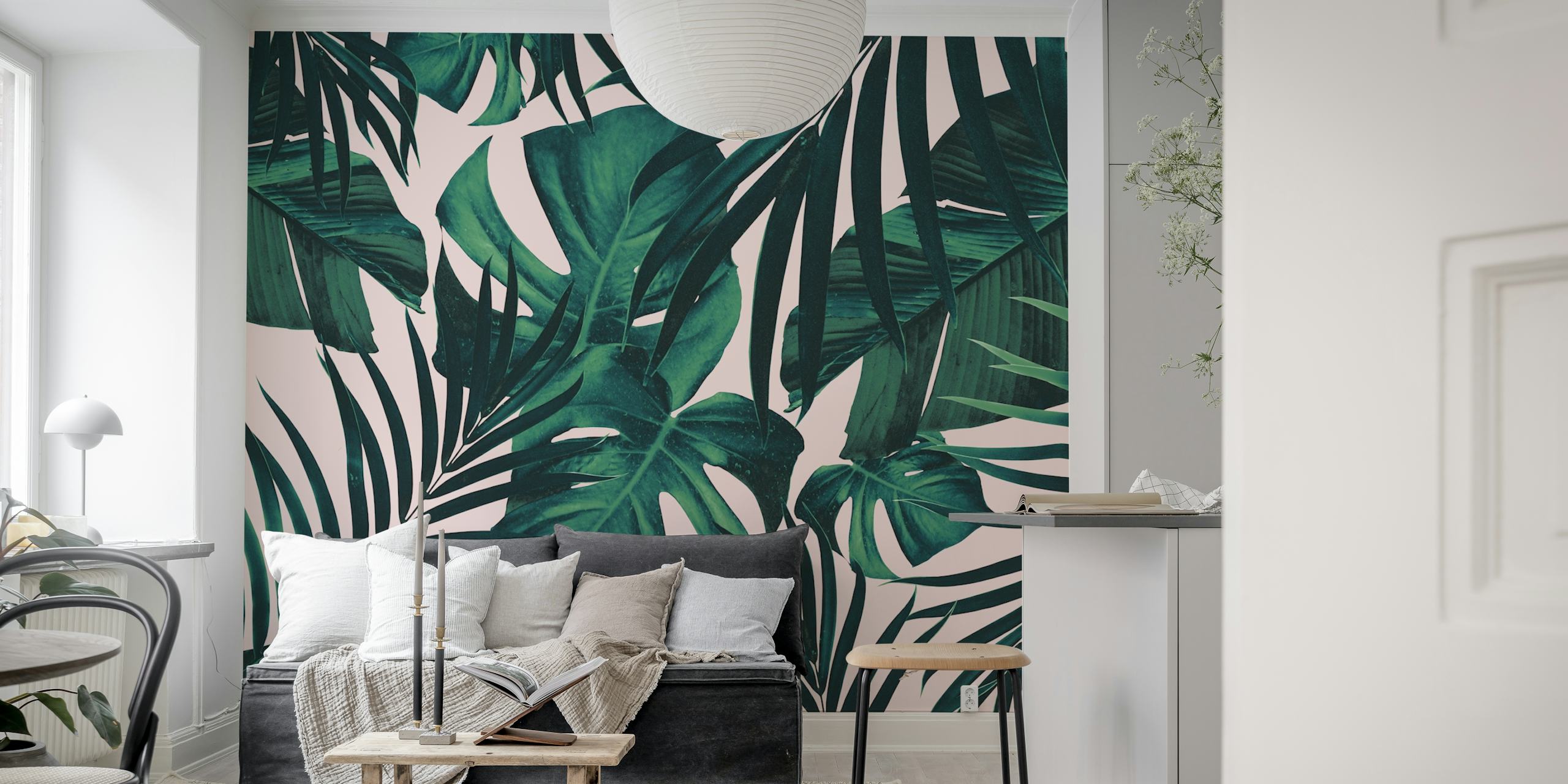 Tropical leaves in green hues on soft pink background wallpaper