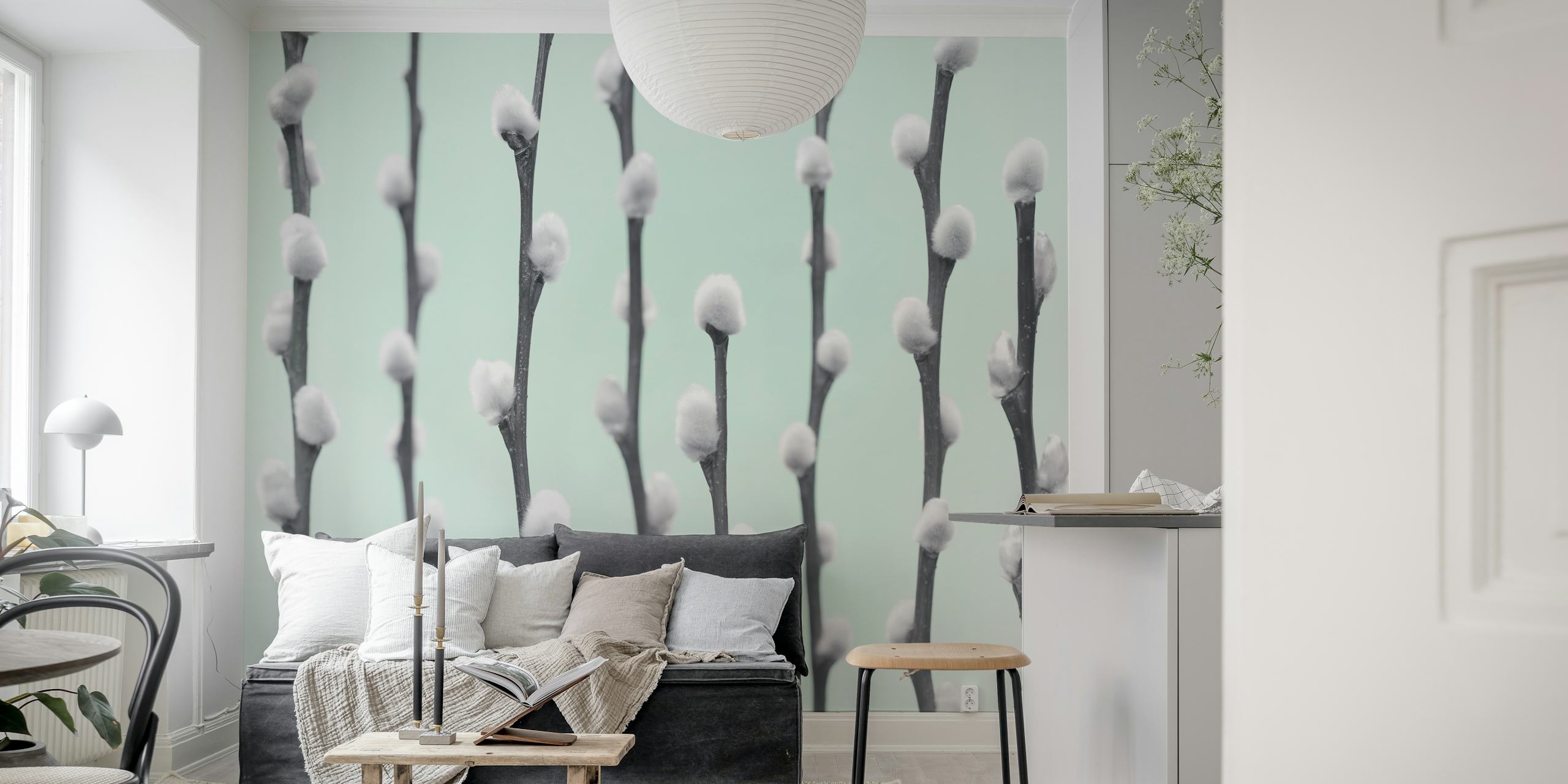 White pussy willow twigs with fluffy buds on light mint wallpaper