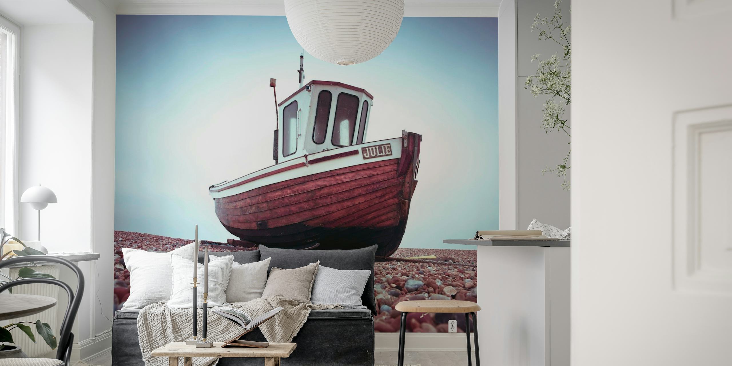 Wall mural of a lone boat on a pebbled beach with overcast skies evoking tranquility and solitude.