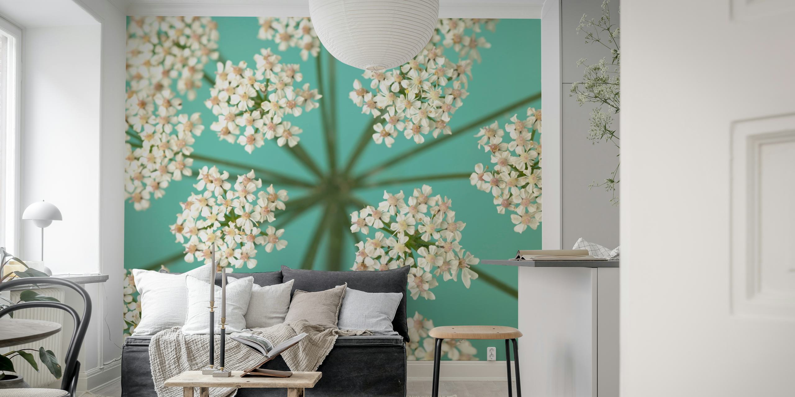 Delicate floral pattern with white and pale pink flowers on teal wallpaper