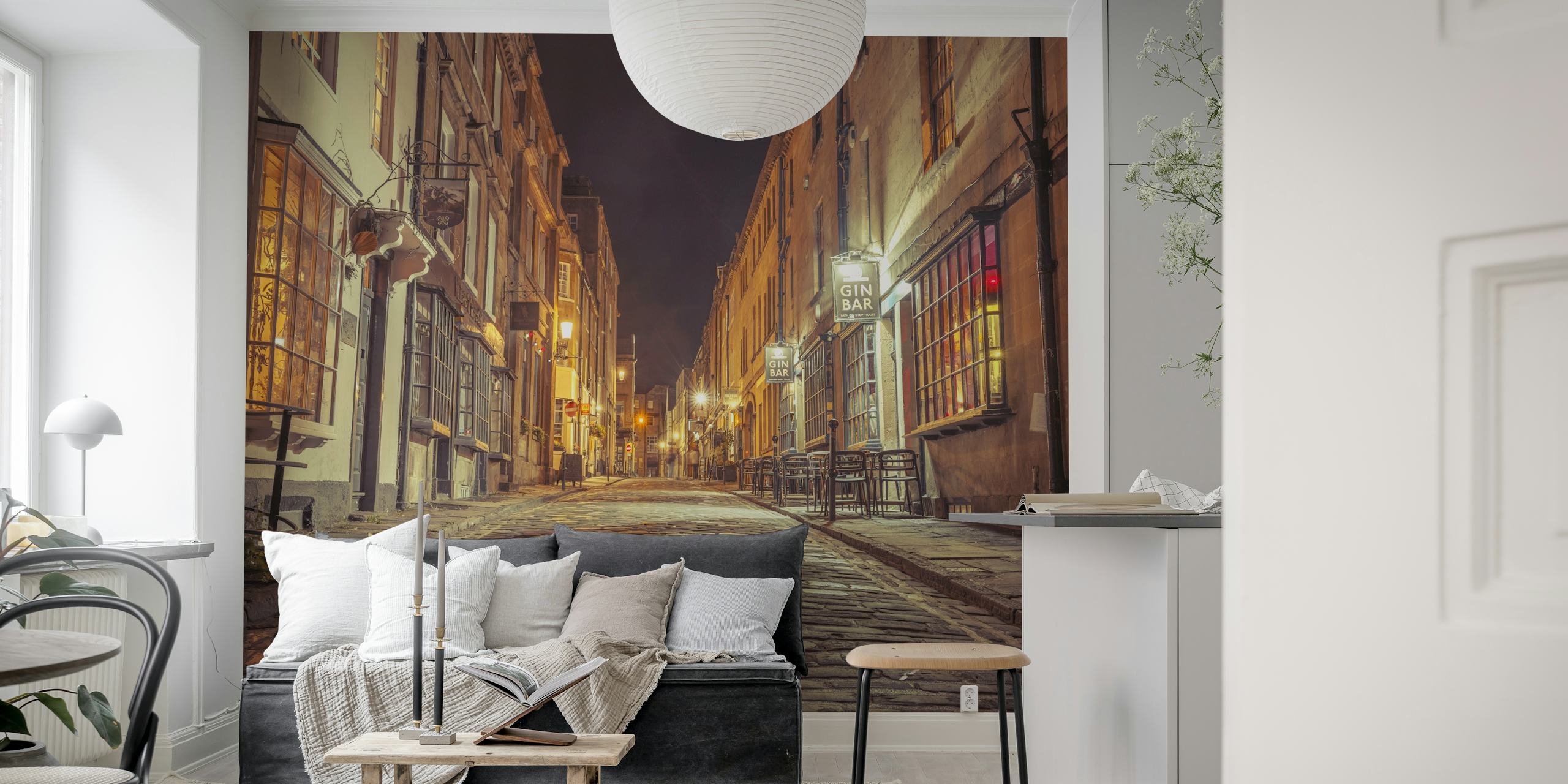 Cobblestone street at night with warm lights wallpaper