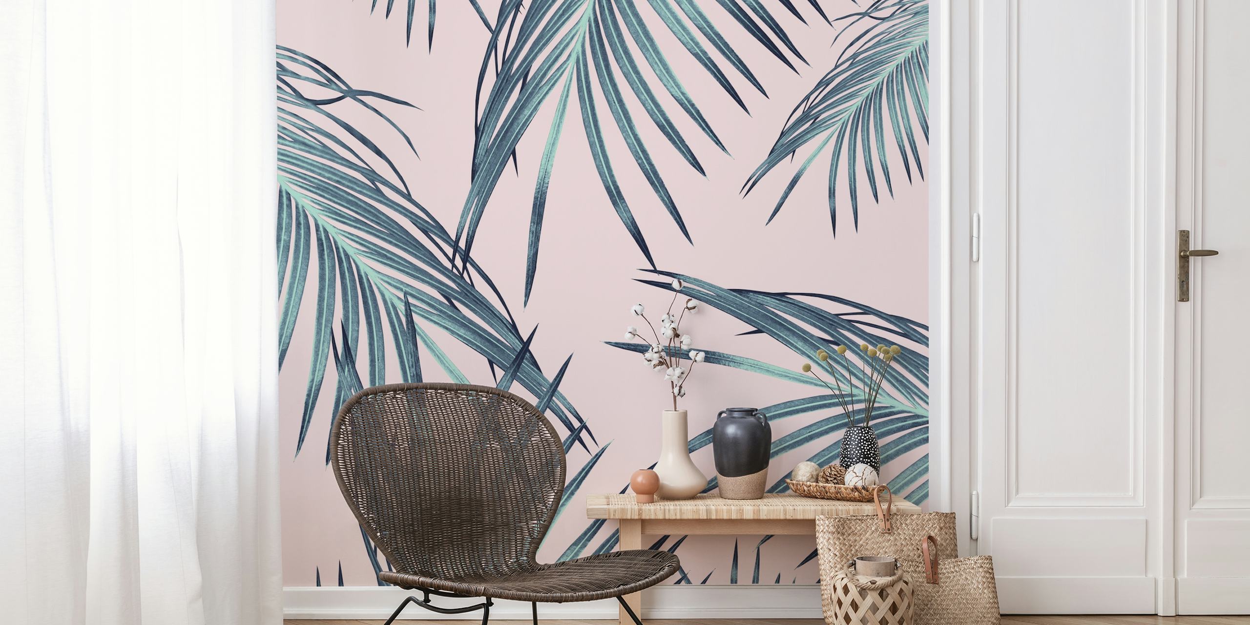 Tropical palm leaves in green and teal colors on pink wallpaper