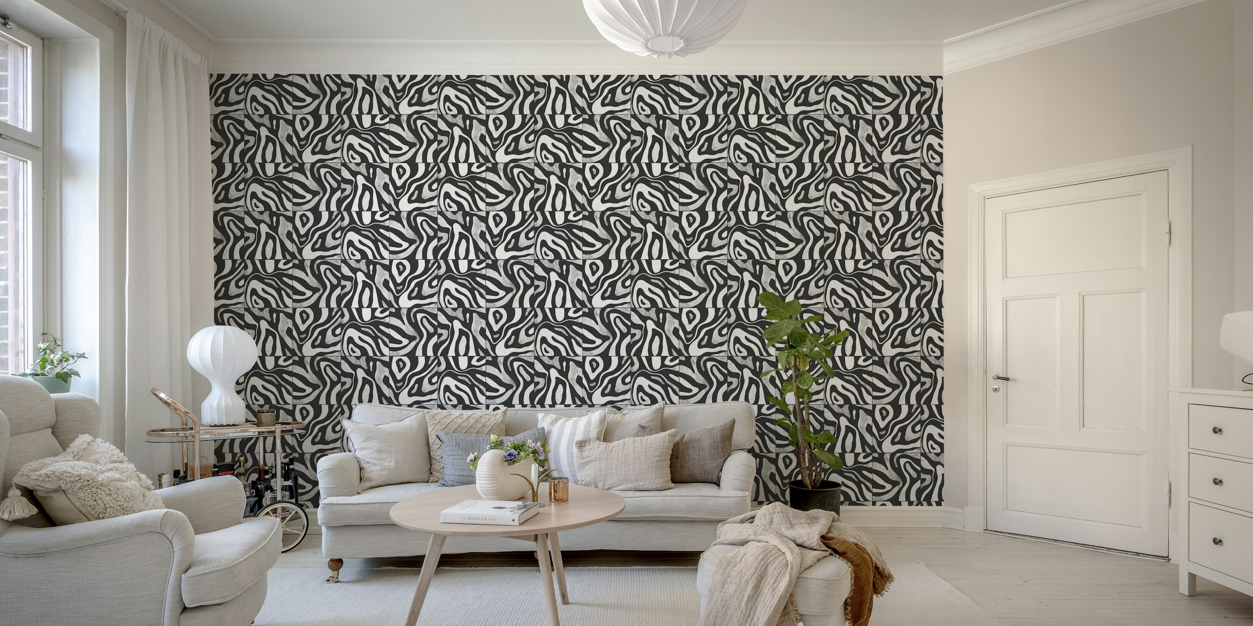 Abstrakti mustavalkoinen seinämaalaus, jossa kukkuloita muistuttava kuvio ylhäältä katsottuna