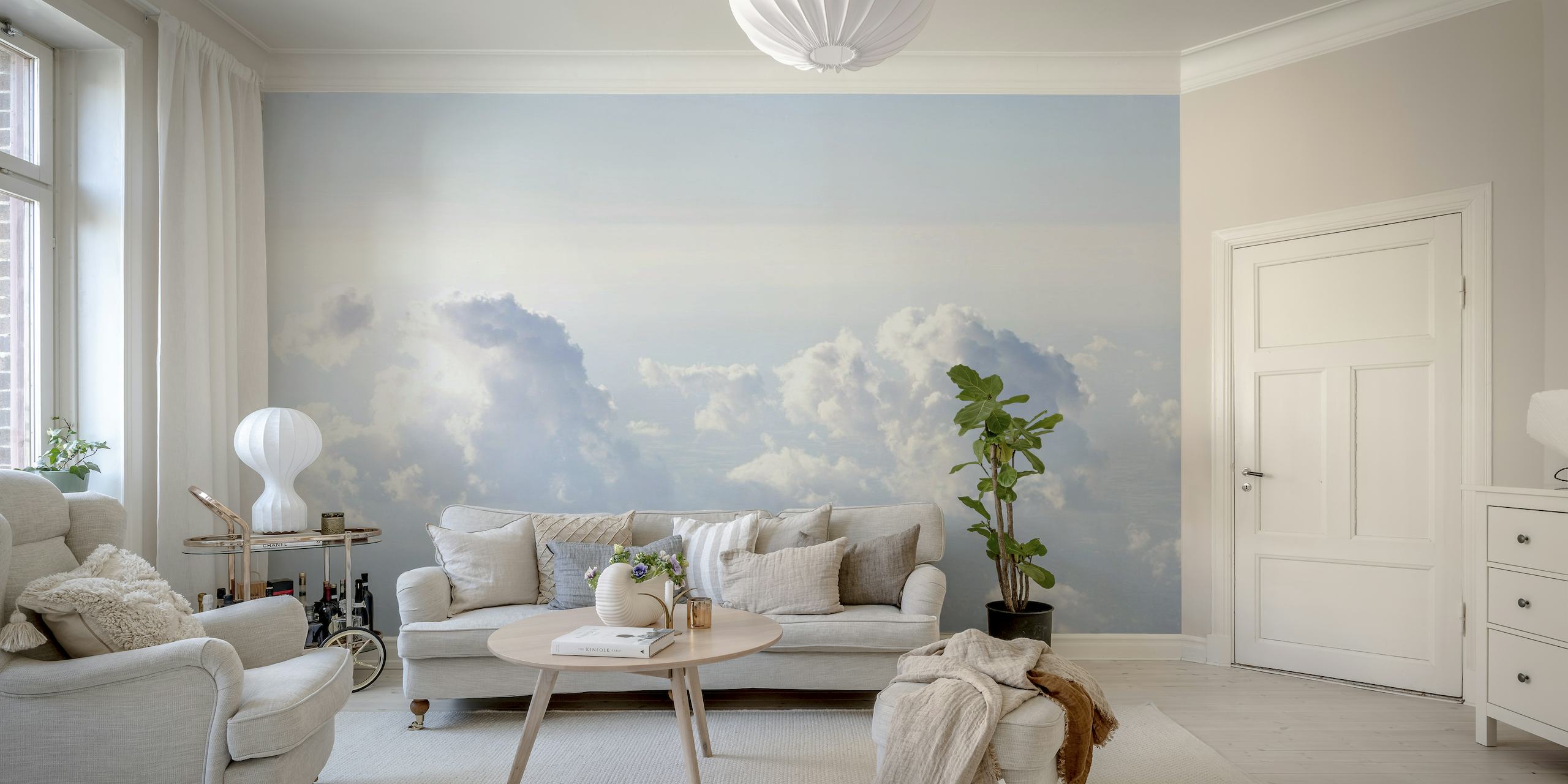 A wall mural of a serene cloud-filled sky with soft blue tones