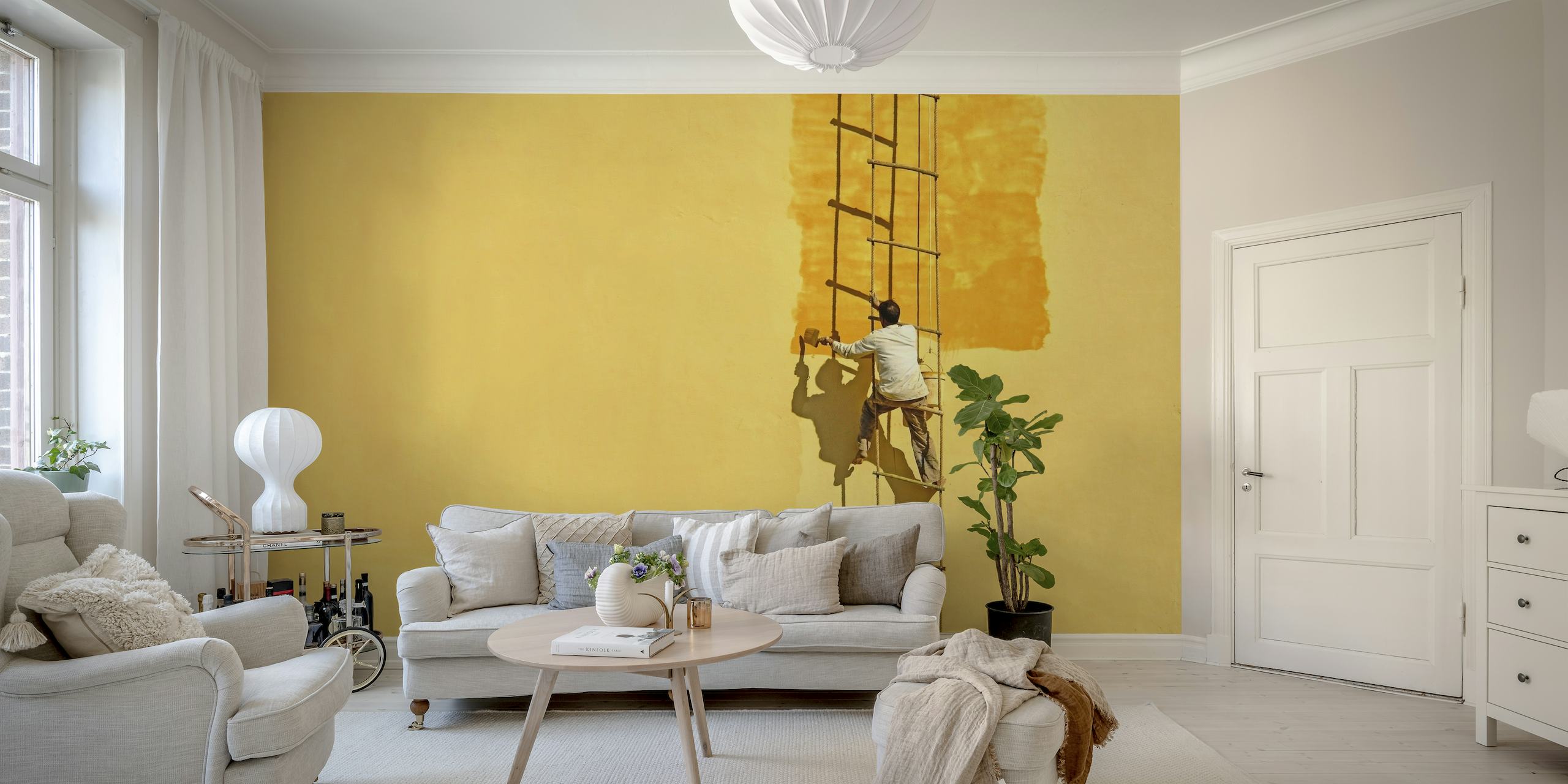 Silhouetted painter on ladder against yellow wall mural