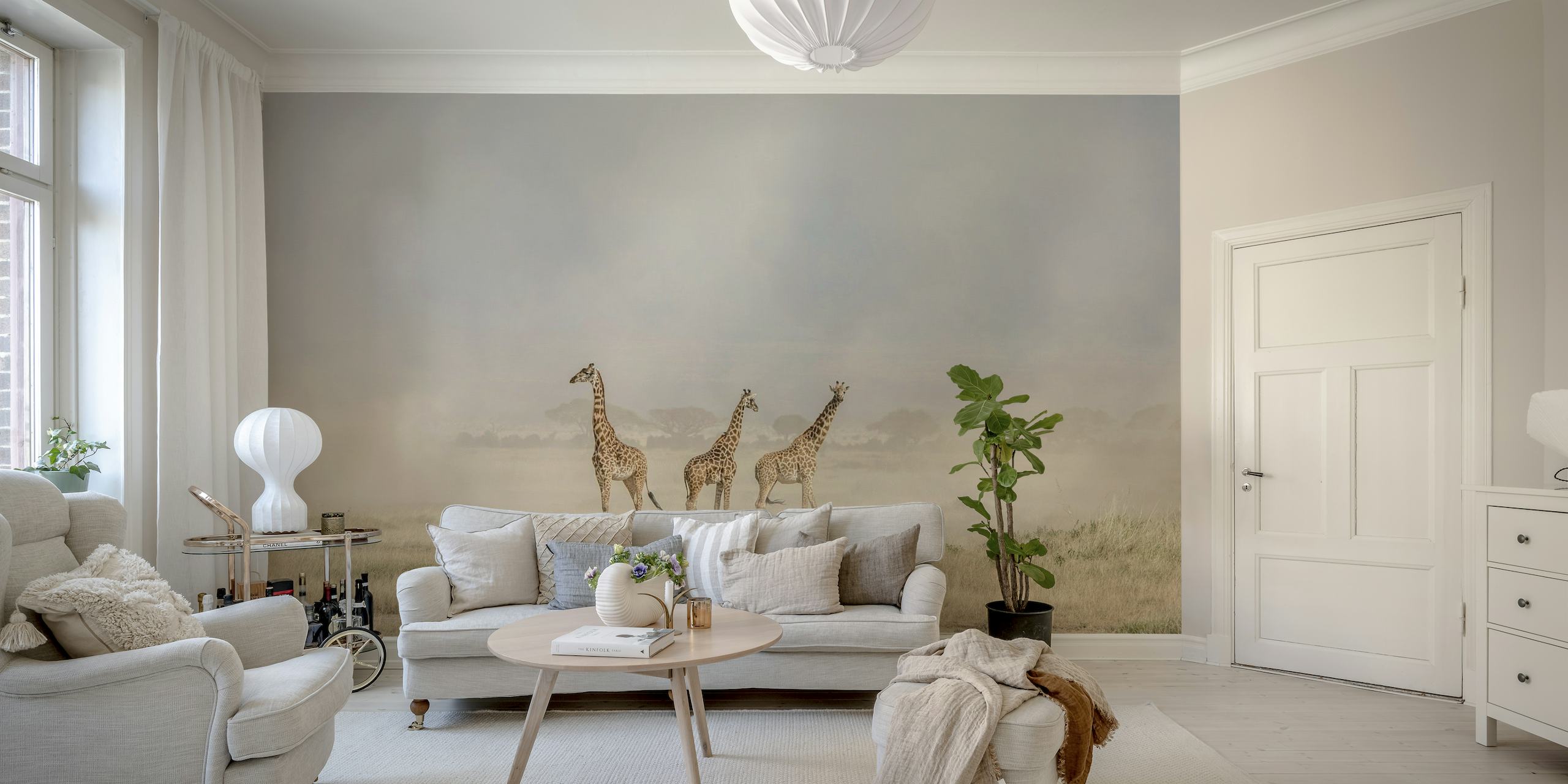 A wall mural depicting giraffes in the dusty Amboseli landscape with dust devils in the background.