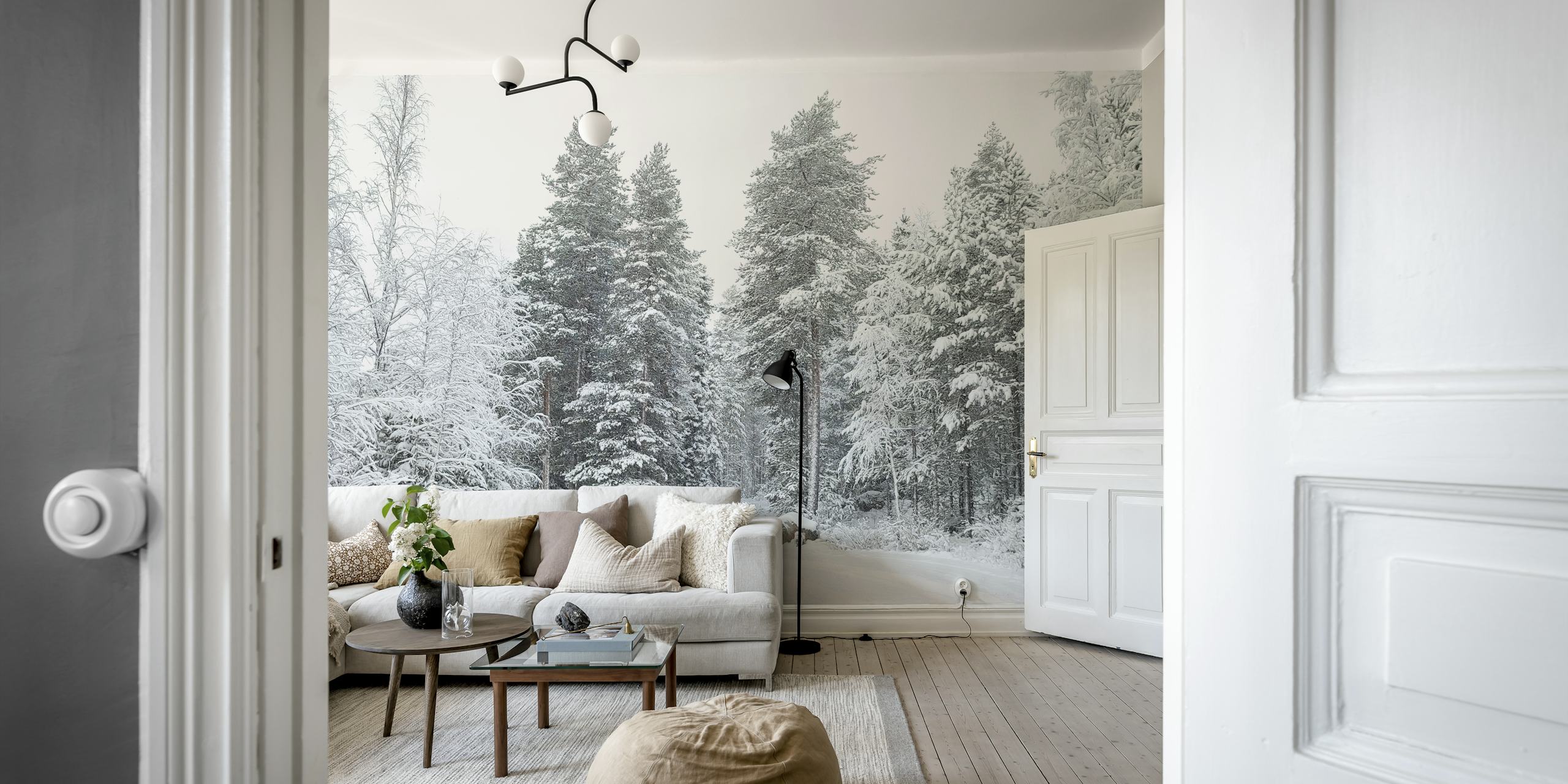 A snowy road meandering through a tranquil forest in Finland, with trees blanketed in snow.
