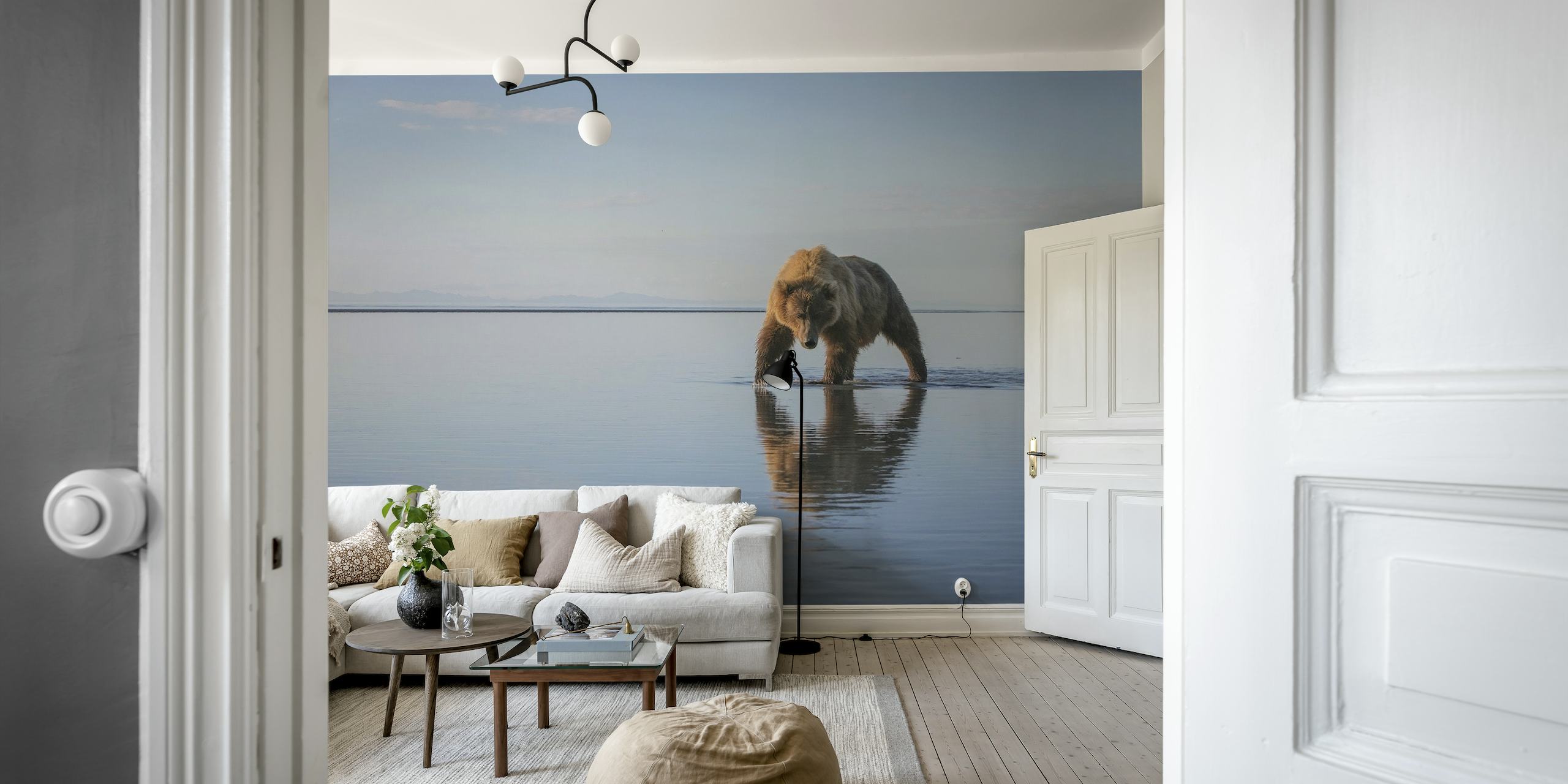 A bear walking along a calm water surface wall mural