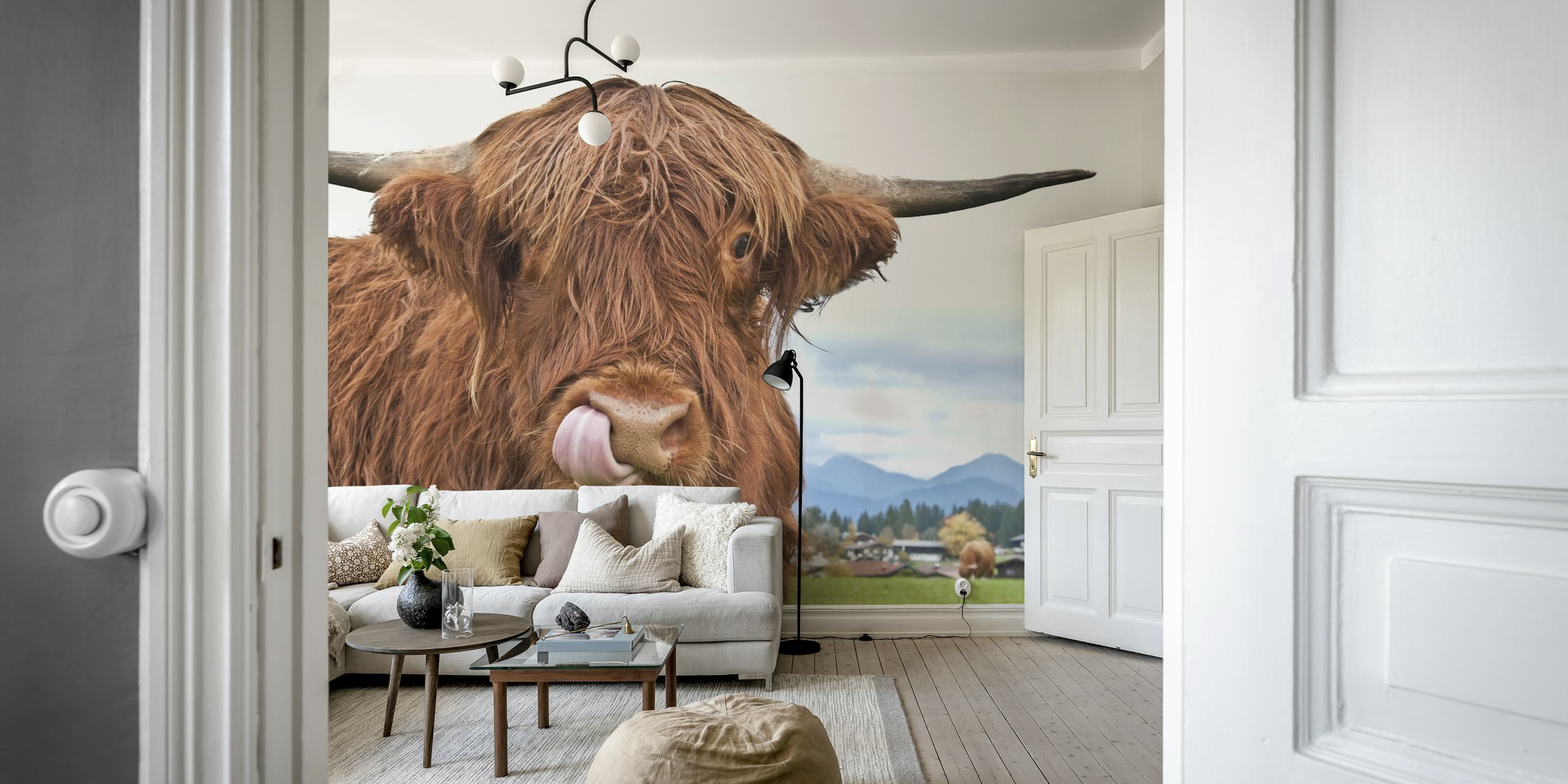 Highland cow with textured reddish fur against green grass and a blue sky wallpaper