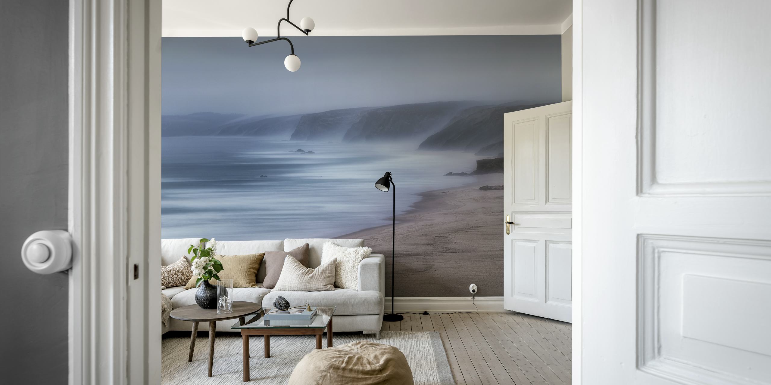Misty beach and ocean wall mural with soft blues and neutral tones