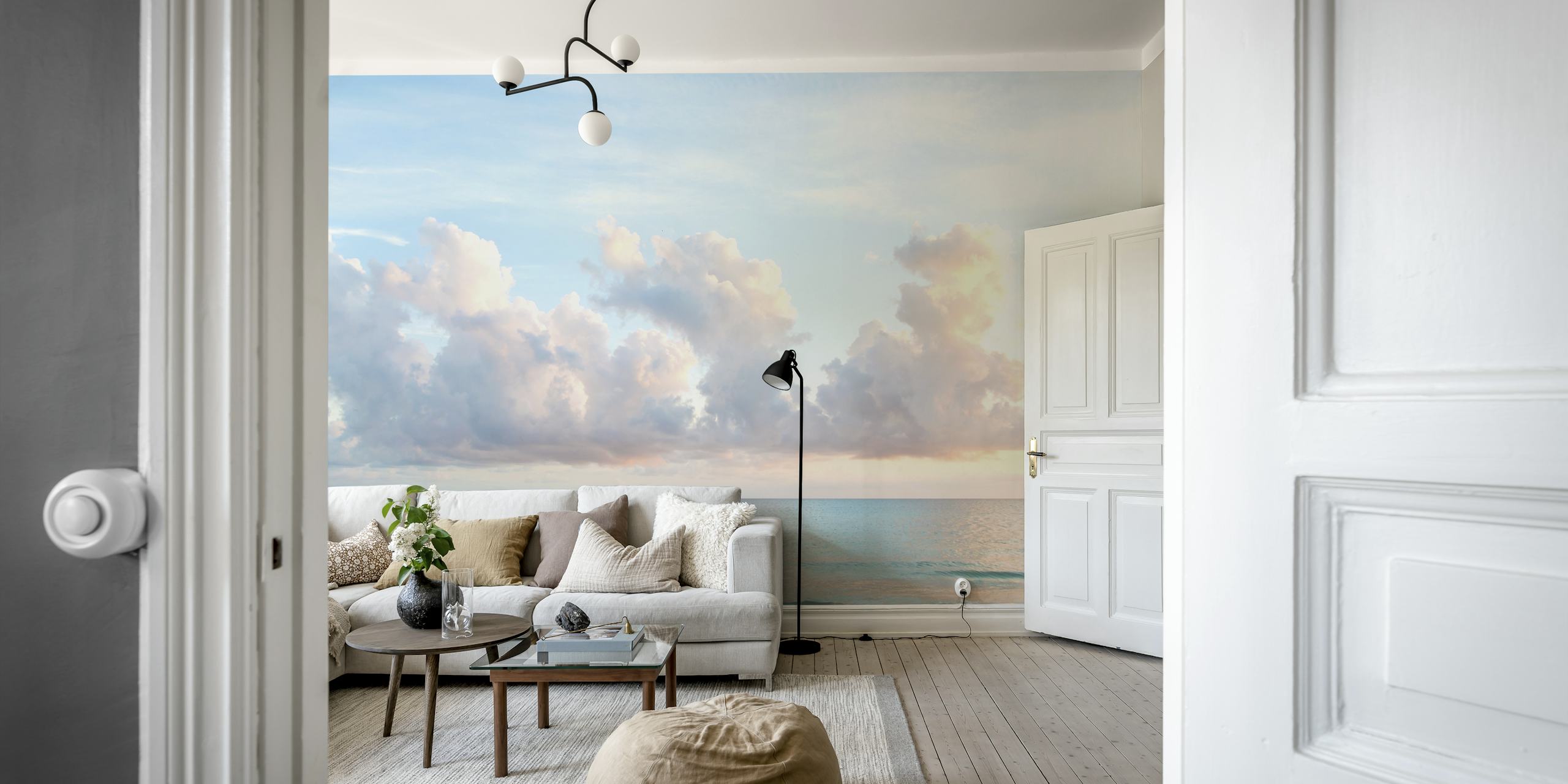 Blue ocean with gentle waves and soft pink clouds wallpaper