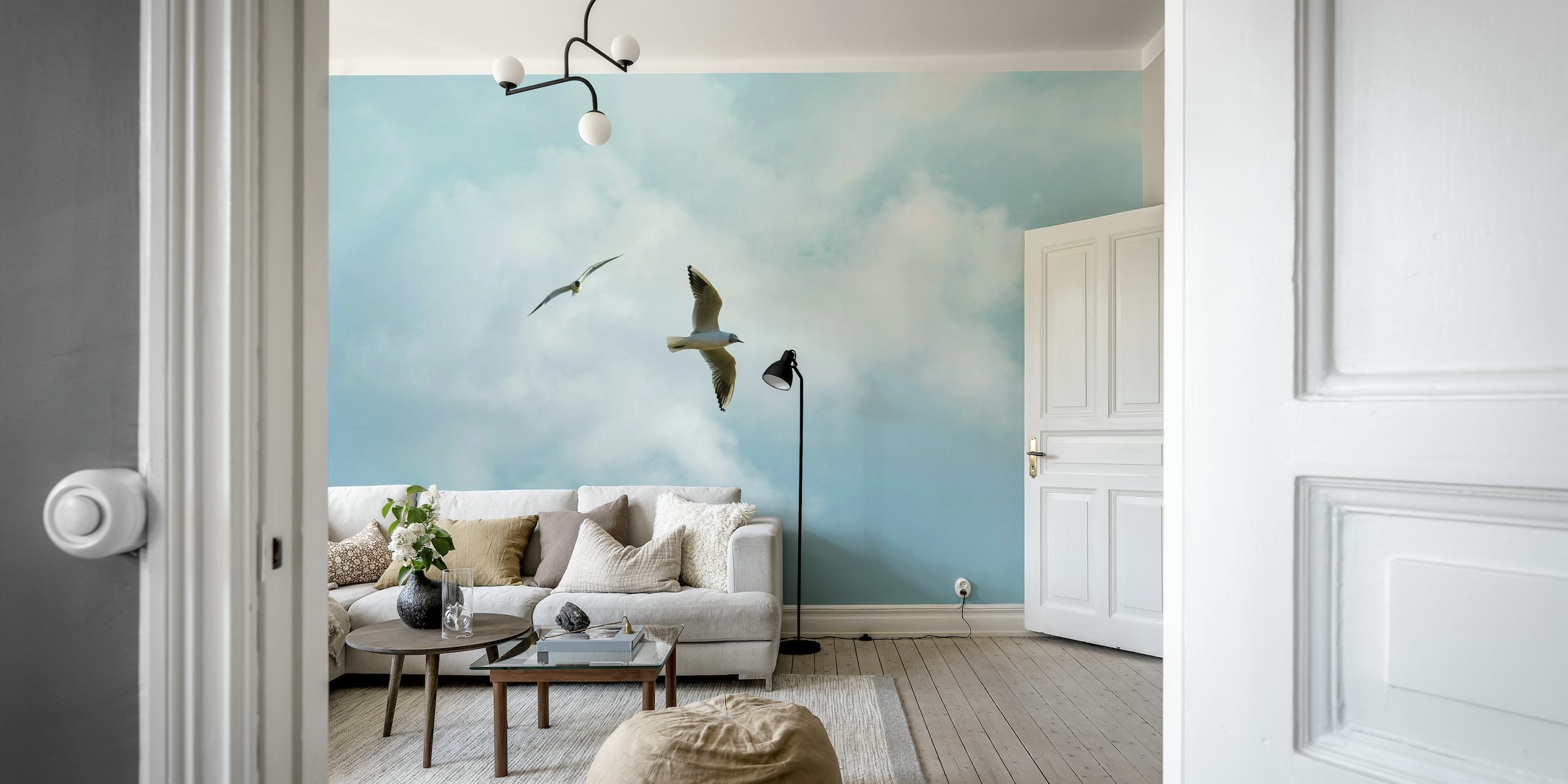 Two seabirds flying in a peaceful sky with fluffy clouds mural