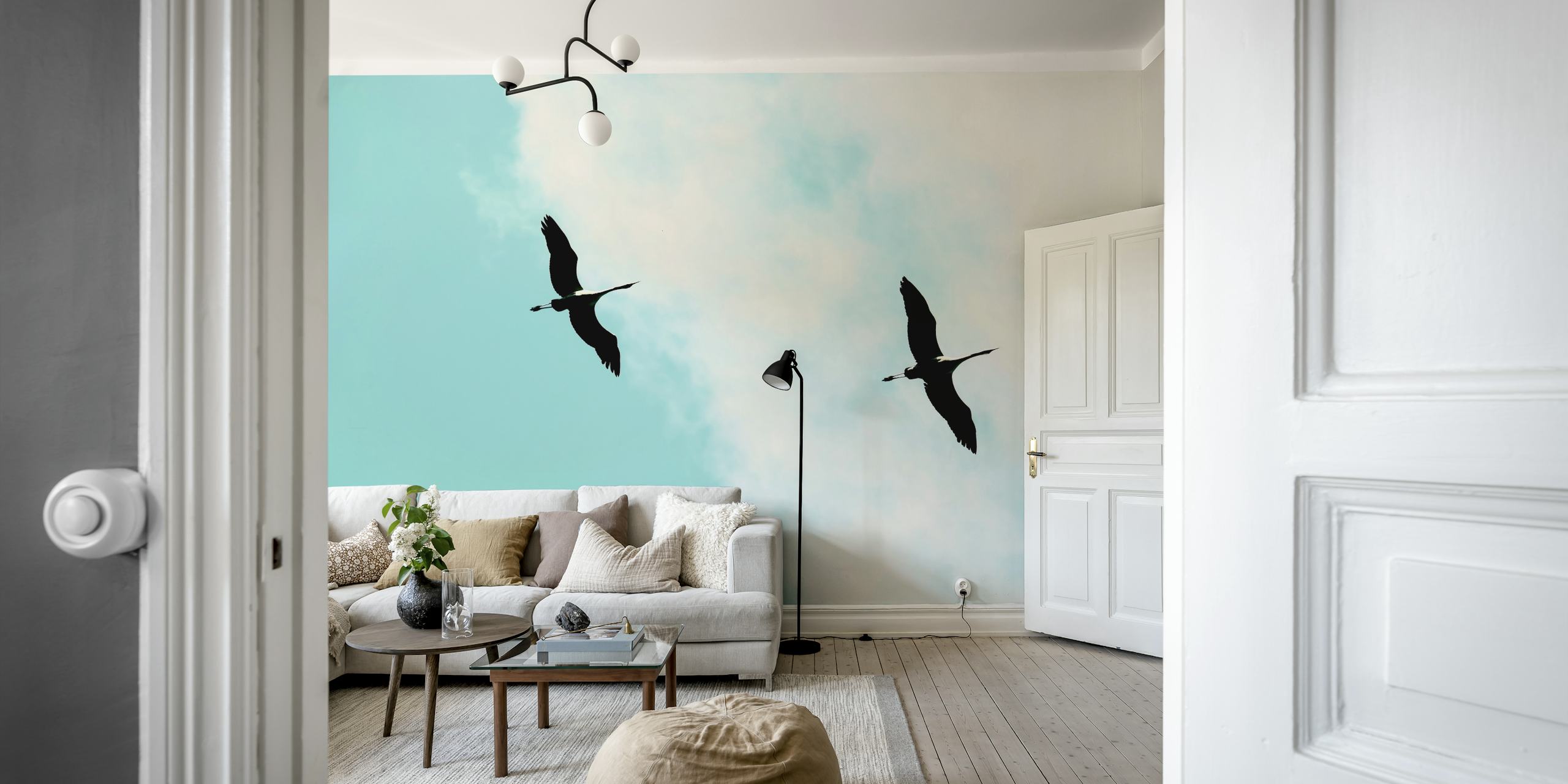 Silhouettes of cranes flying against a blue sky wallpaper