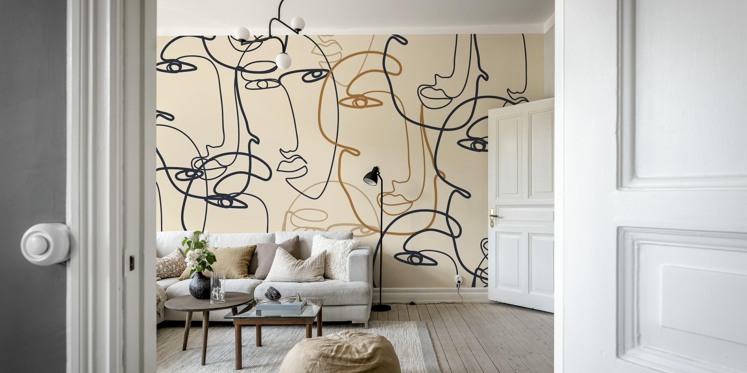Continuous line art of faces in black, orange on beige wallpaper