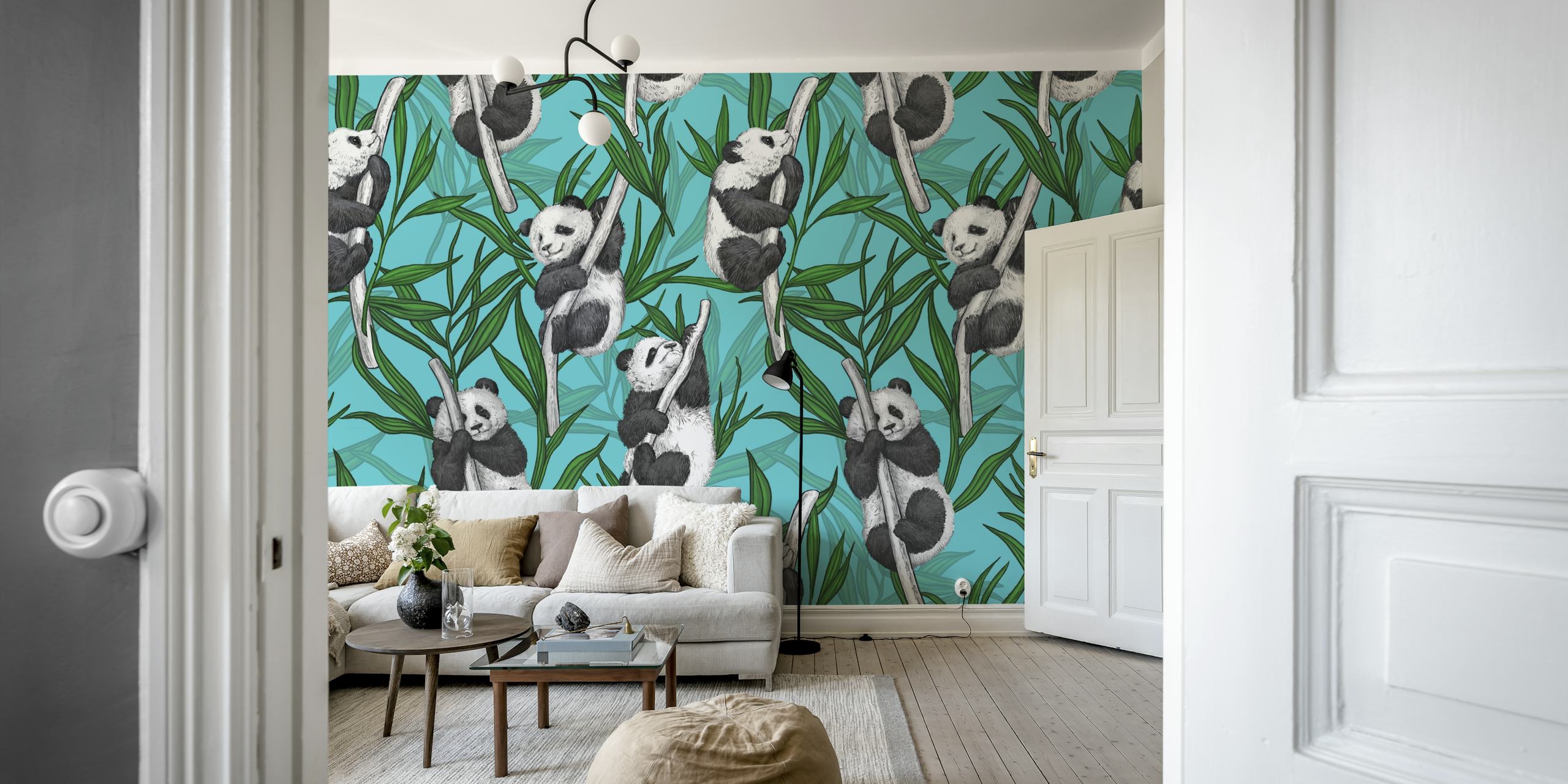 Panda cubs playing in greenery on turquoise wall mural