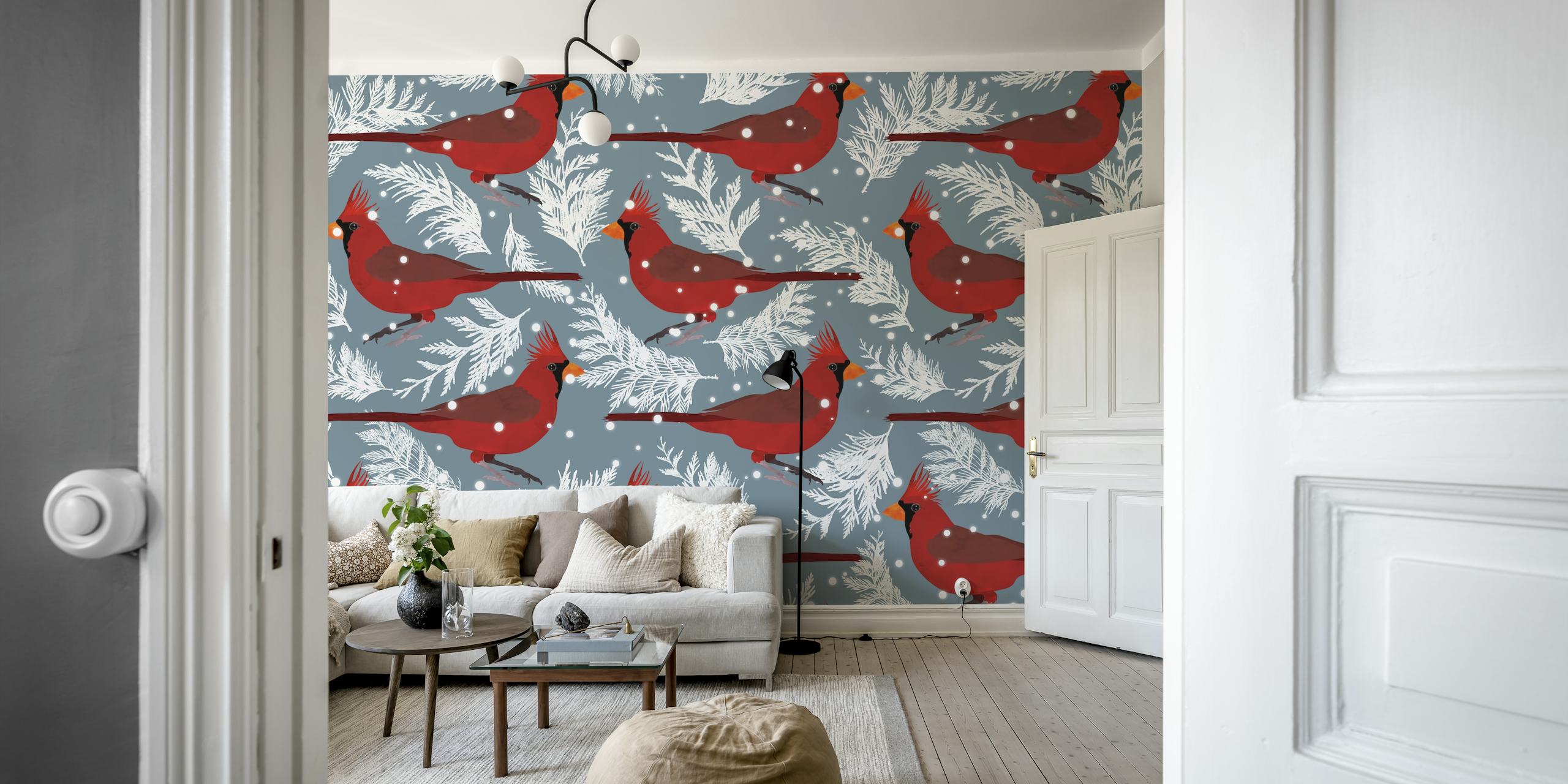 Red cardinals on white branching leaves against a blue background wallpaper